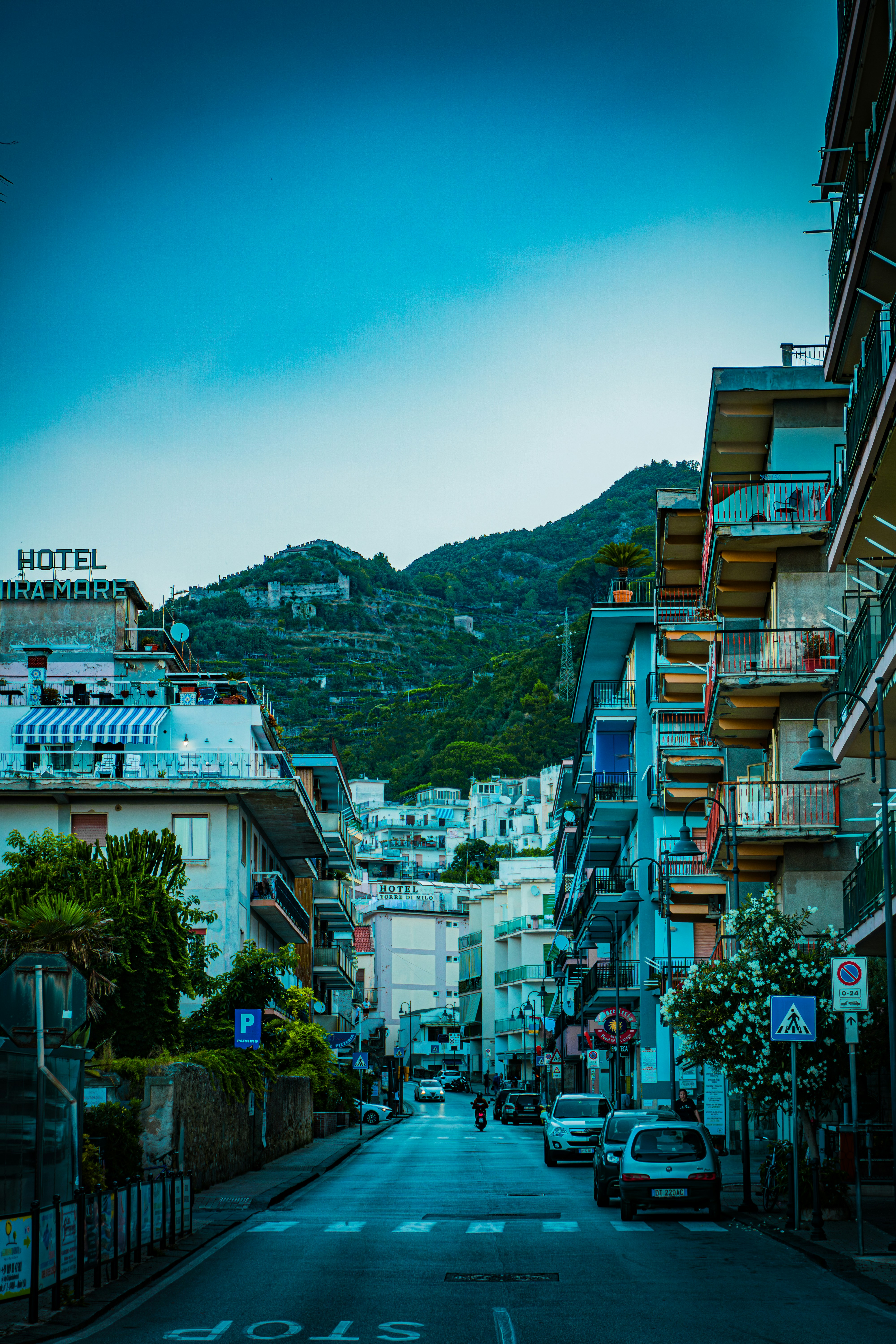 A city street with a mountain in the background