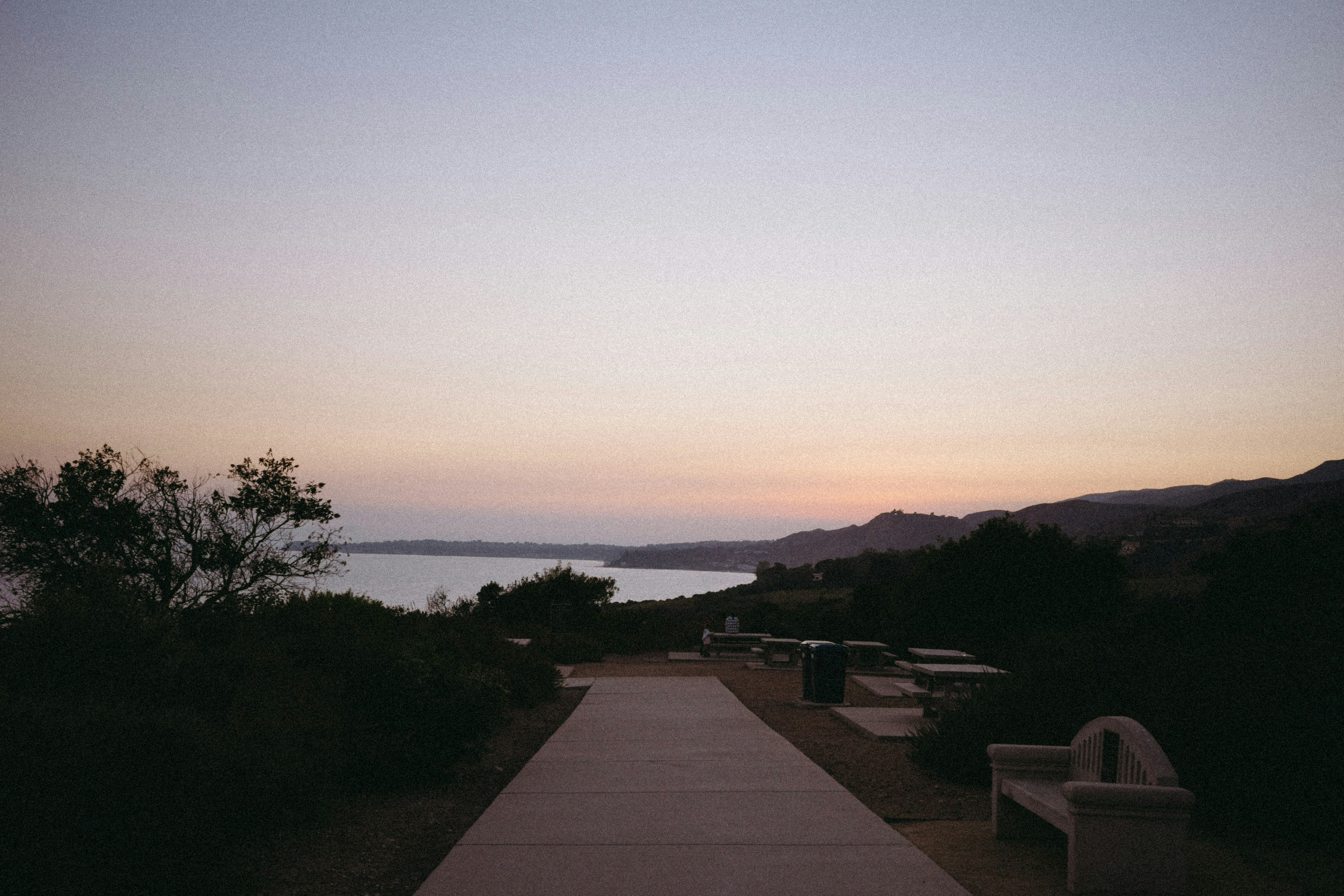A path leading to a beach at sunset