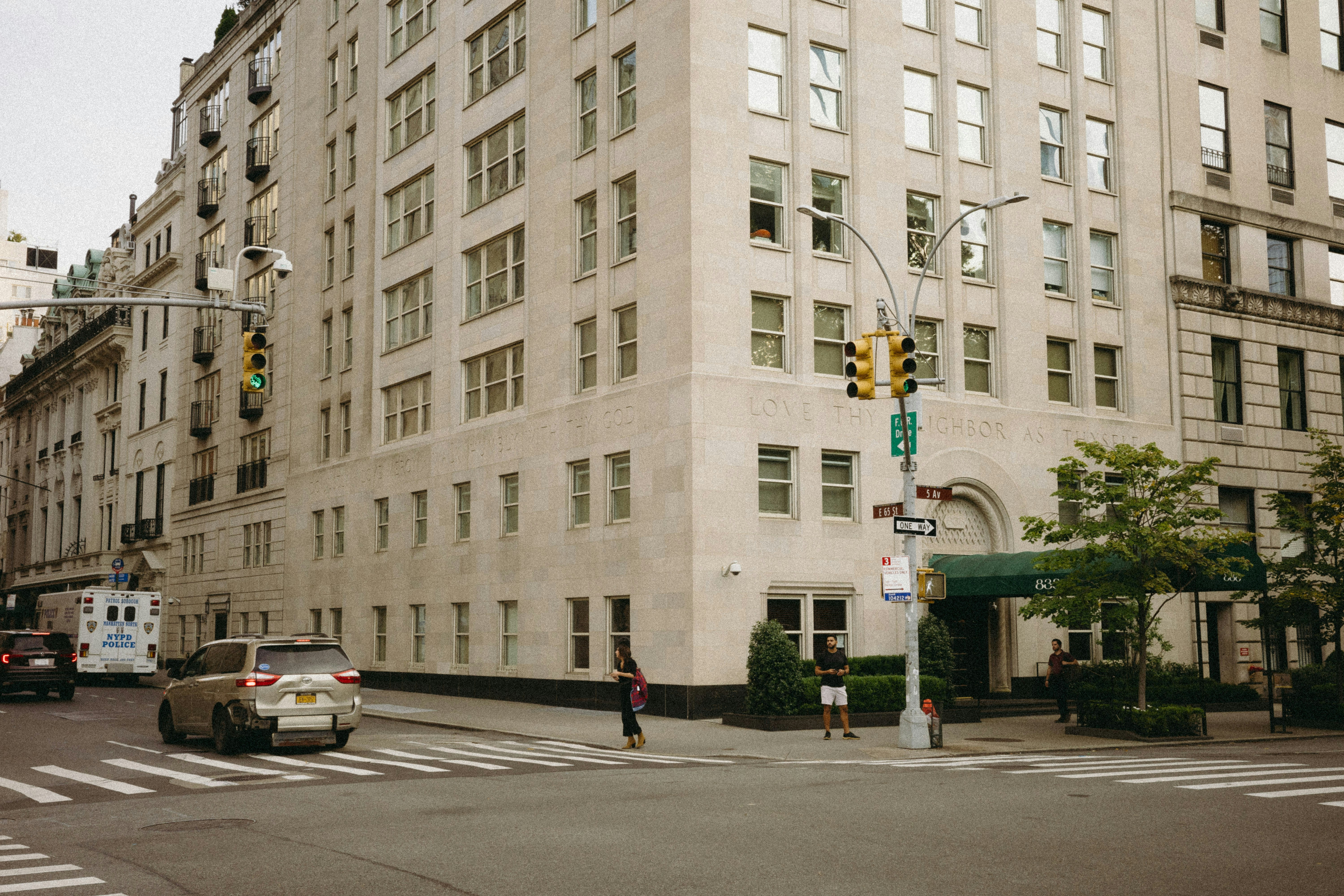 A large white building sitting on the corner of a street
