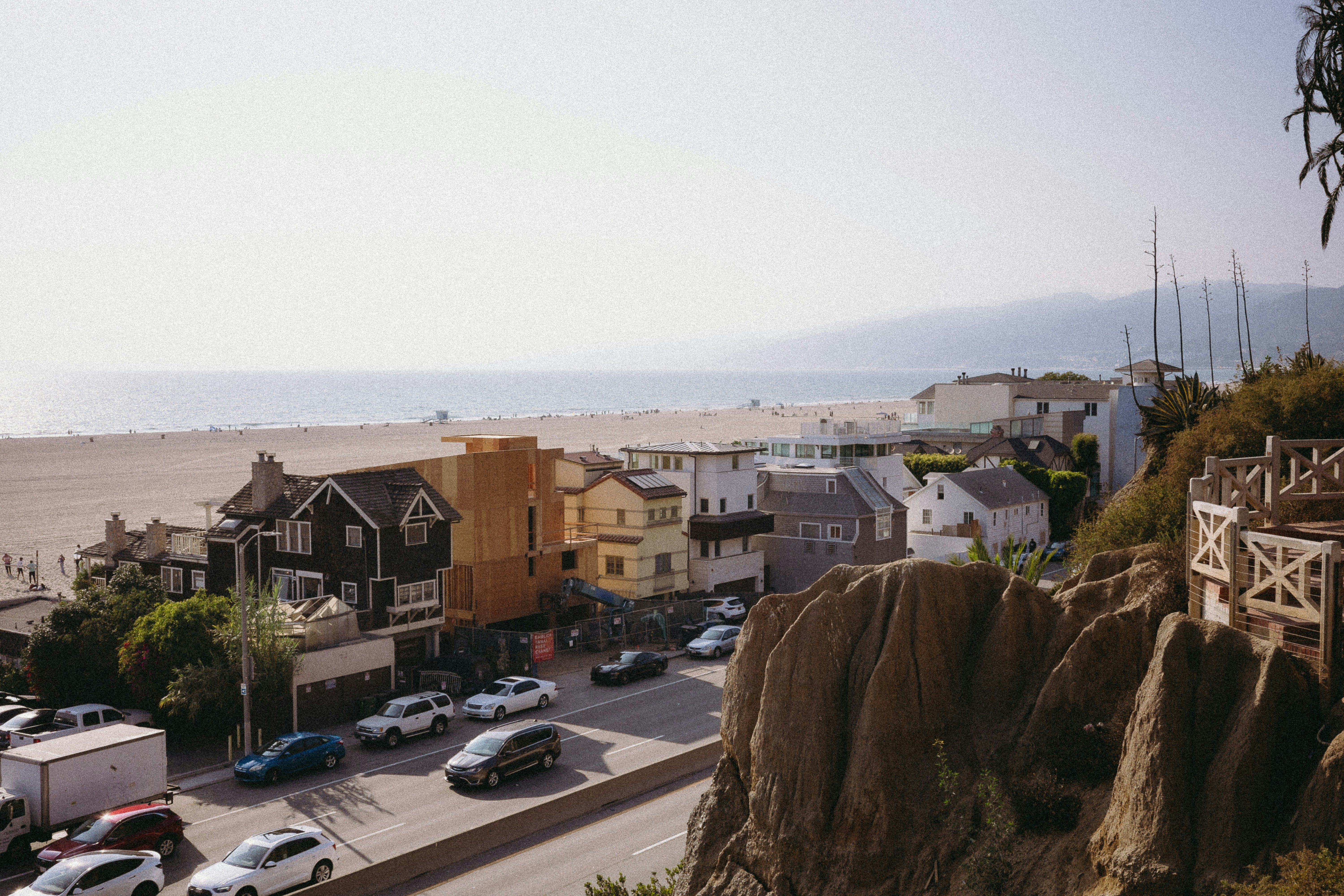 A view of a street with cars parked on the side of the road