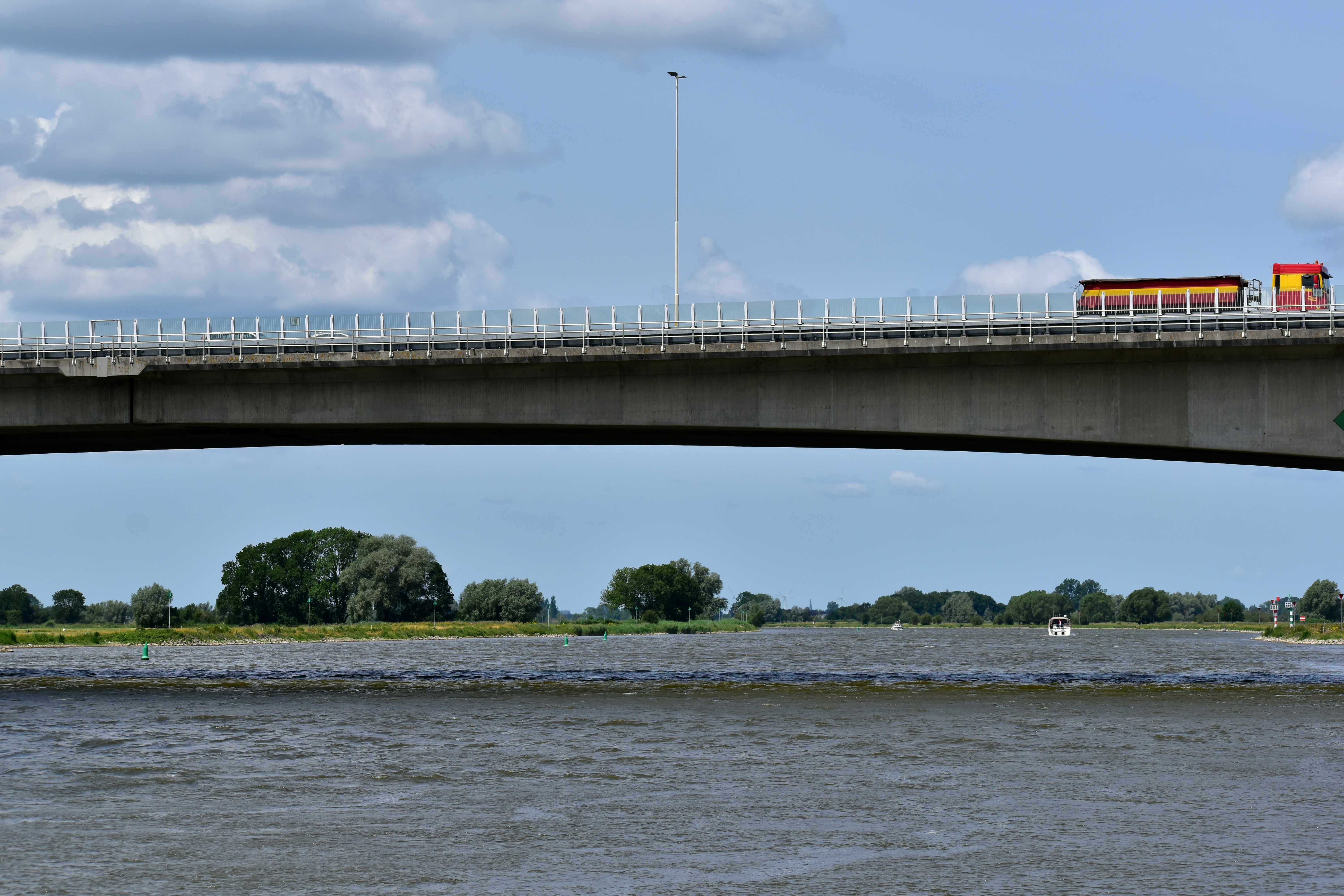 A bridge over a body of water with a train on it
