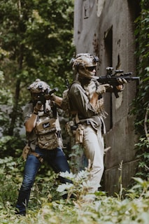 A couple of people that are standing in the grass