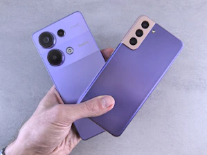 A person holding a purple phone in their hand