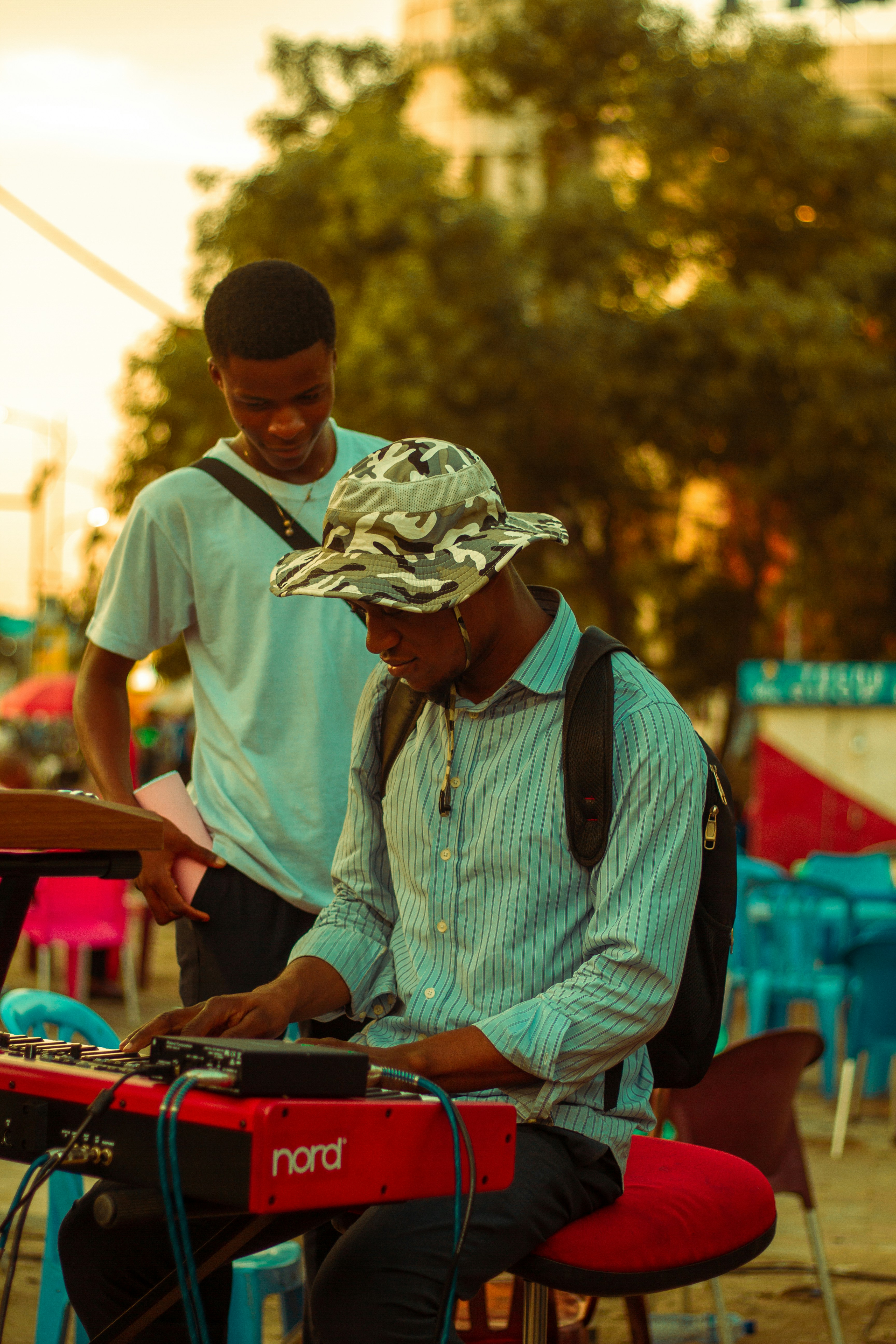 A man sitting in a chair playing a keyboard