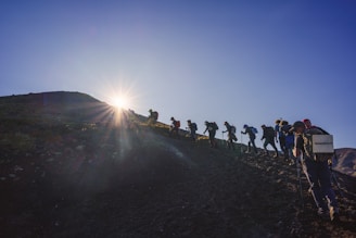 A group of people walking up a hill