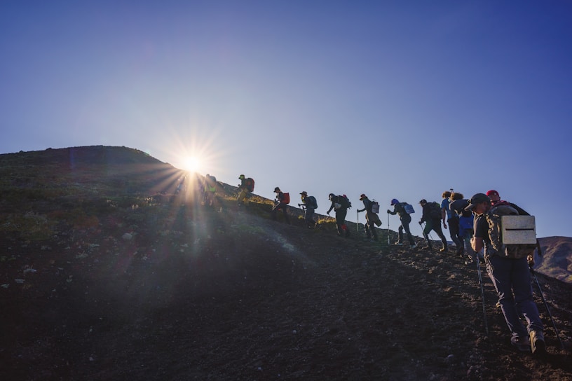 A group of people walking up a hill