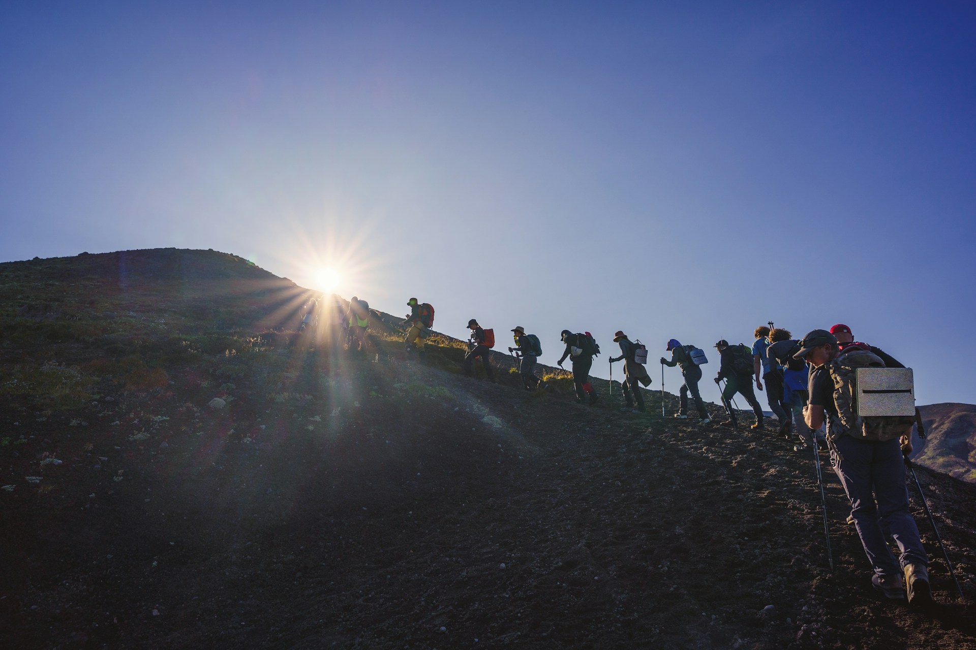 A group of people walking up a hill