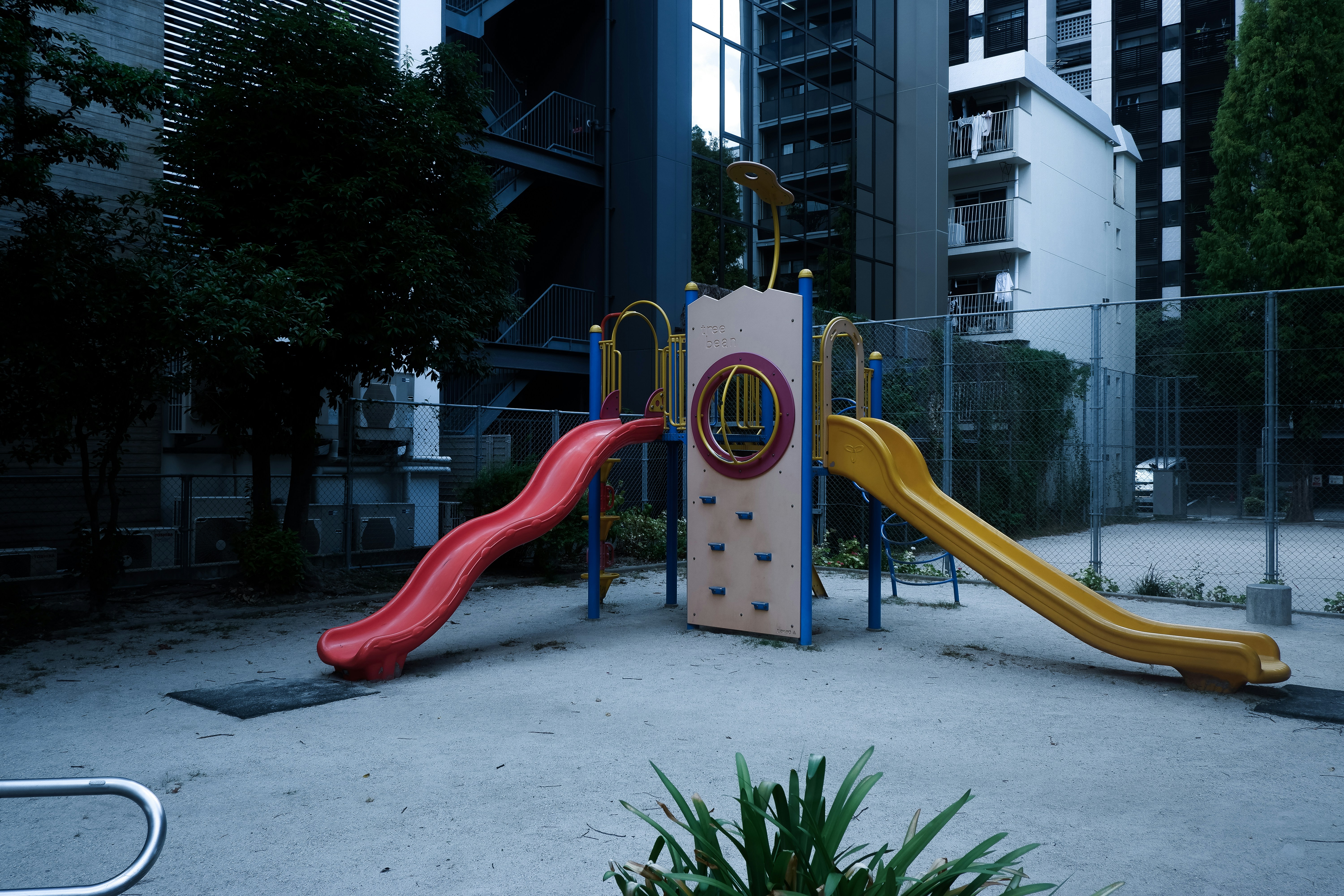 A children's play area with a slide and climbing frame