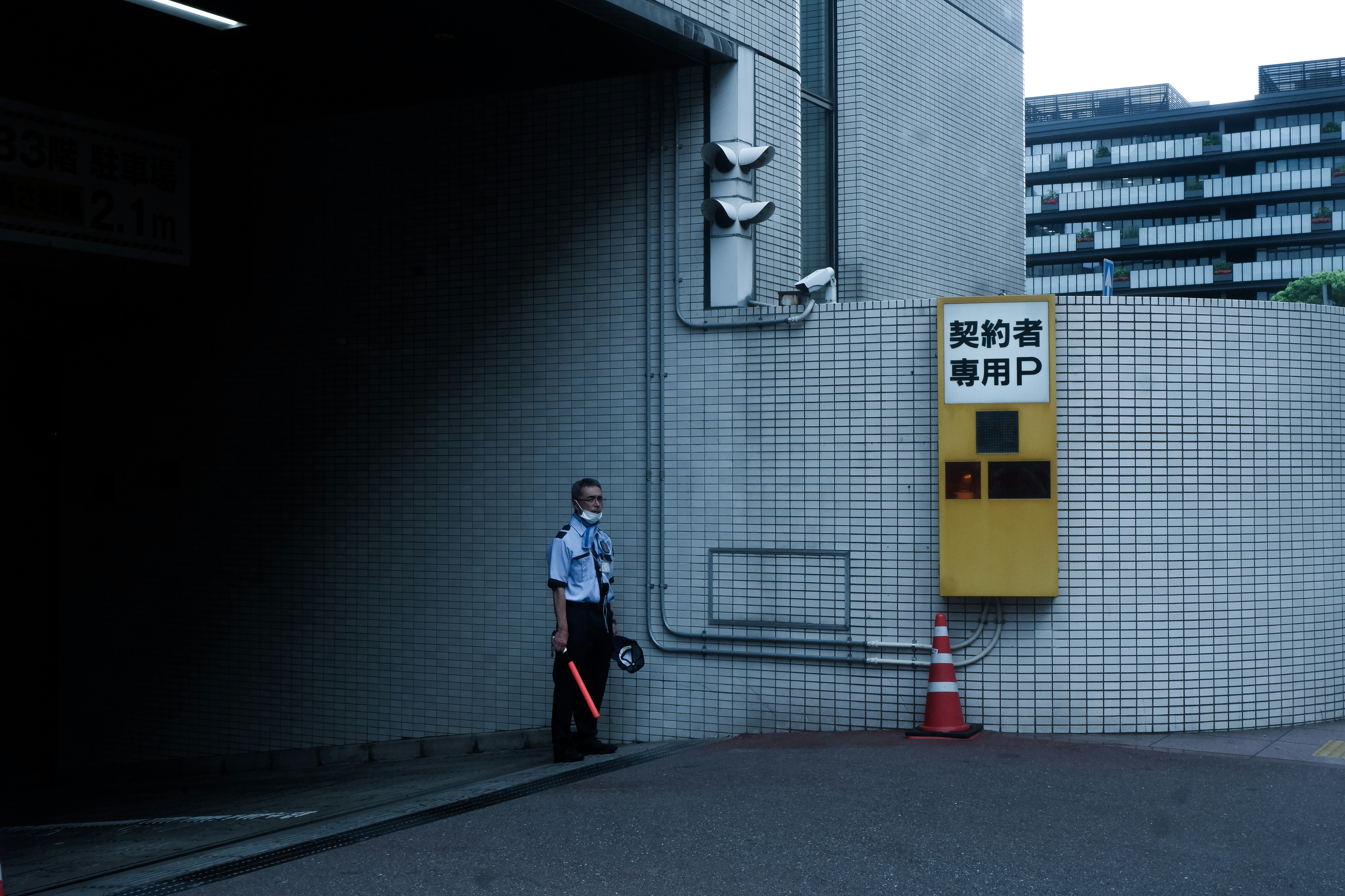 A man standing in a parking garage next to a fire hydrant