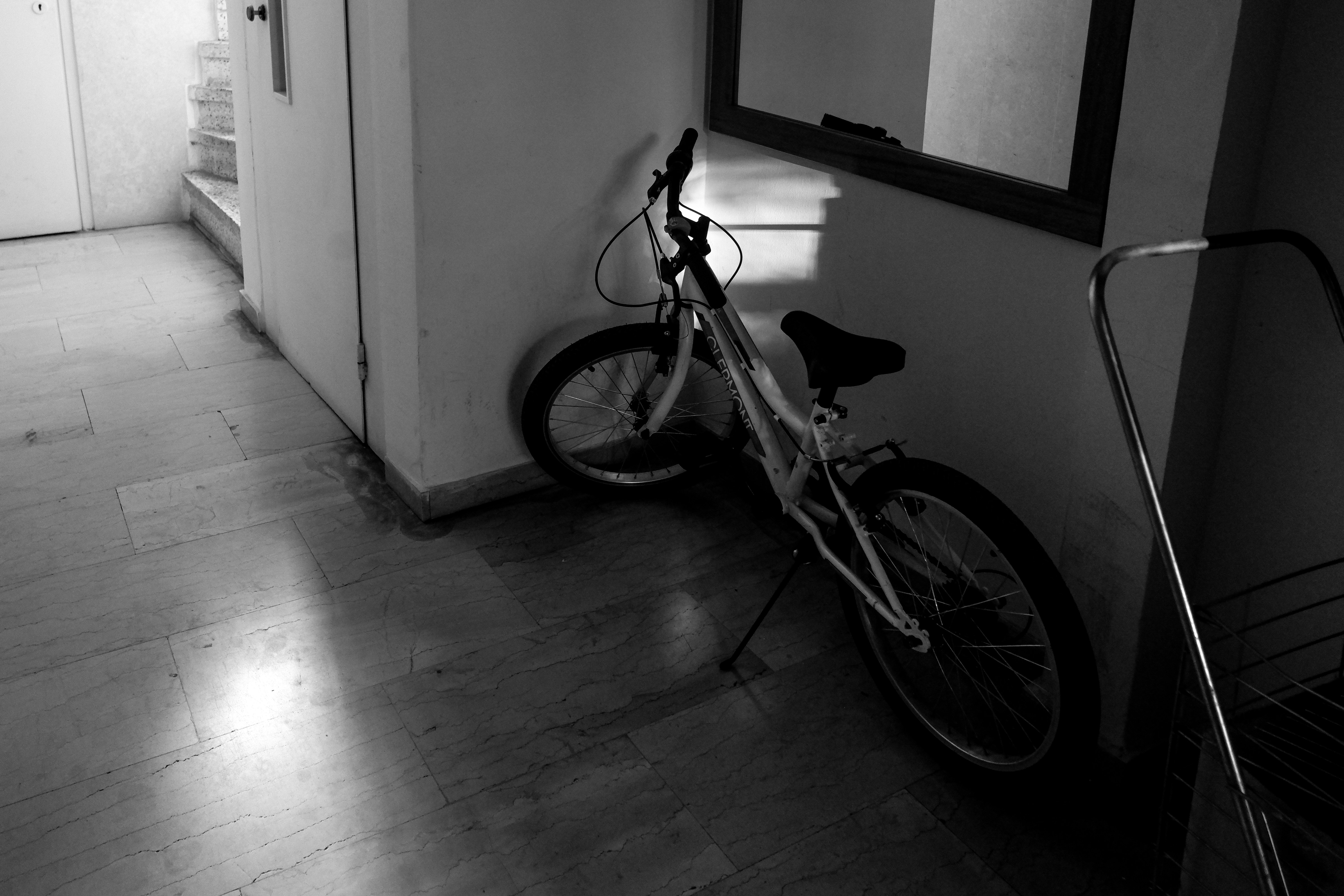 A bike leaning against a wall in a hallway
