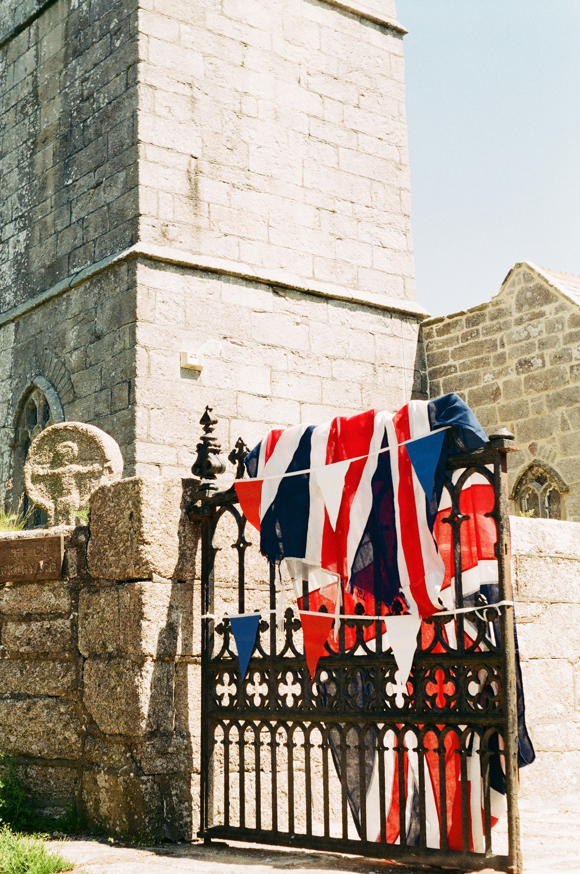 A gate with a bunch of flags on it