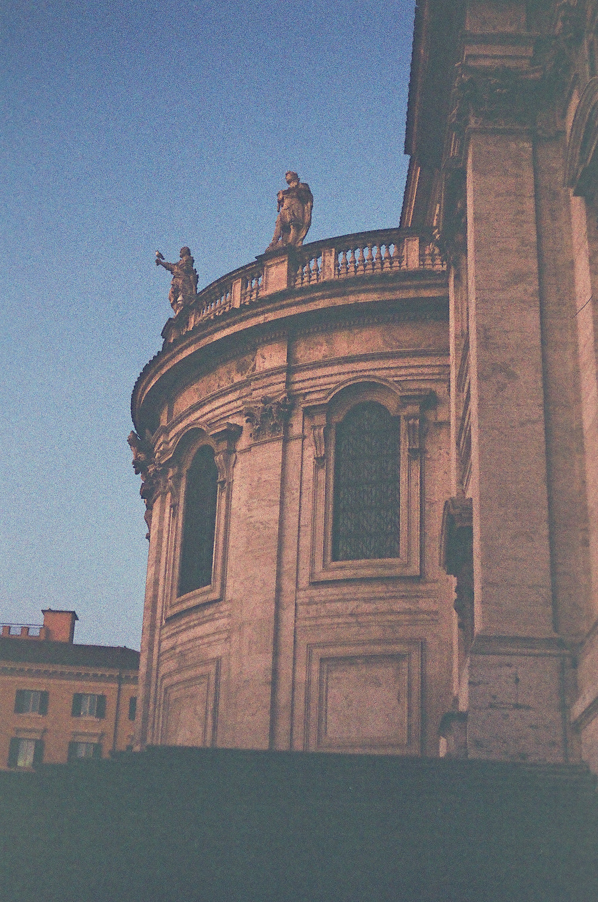 A clock tower with statues on top of it