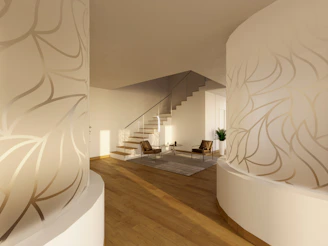 A room with a staircase and a plant on the wall