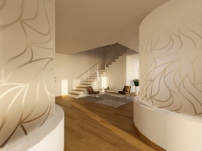 A room with a staircase and a plant on the wall