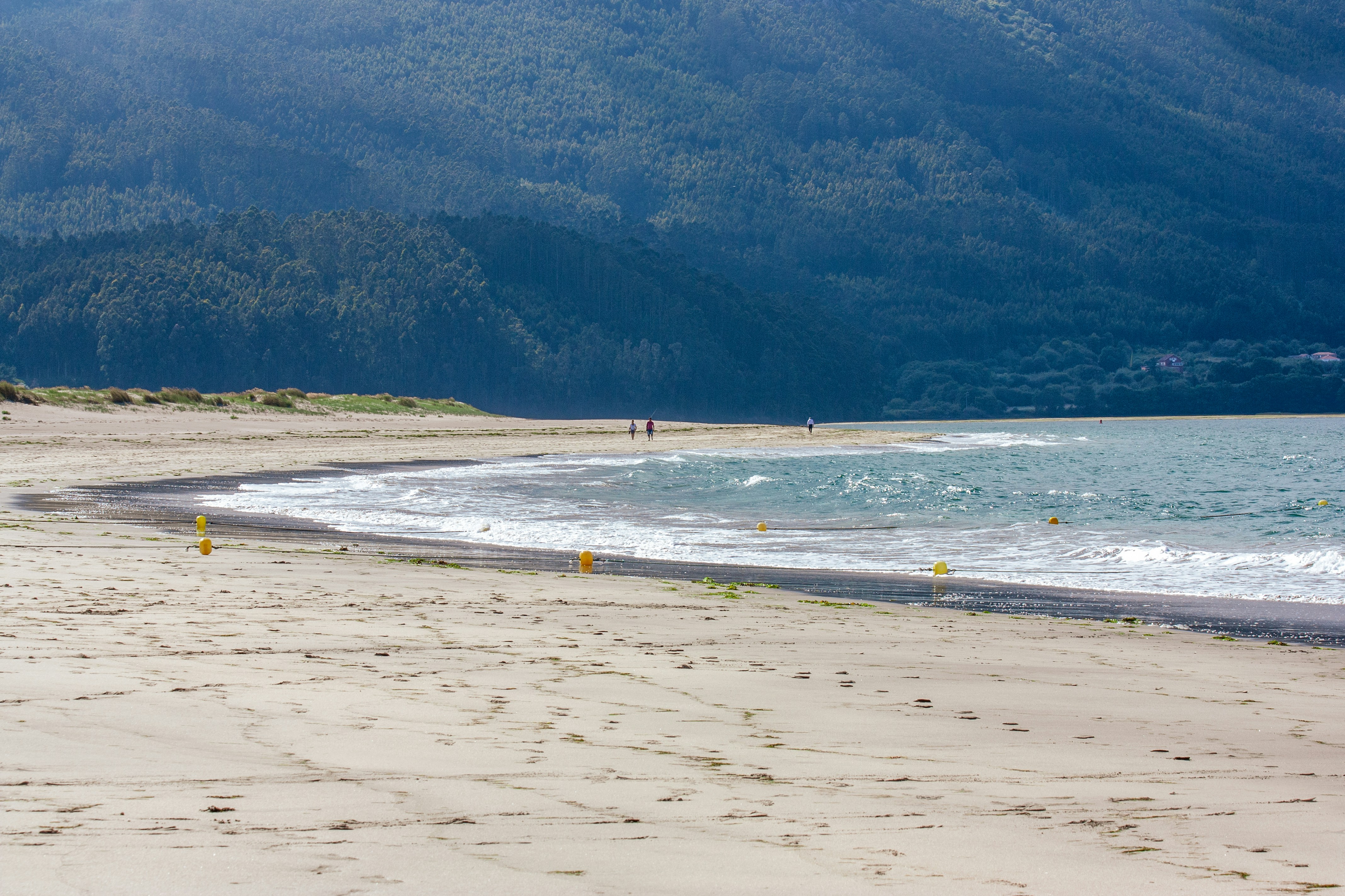 A sandy beach with mountains in the background