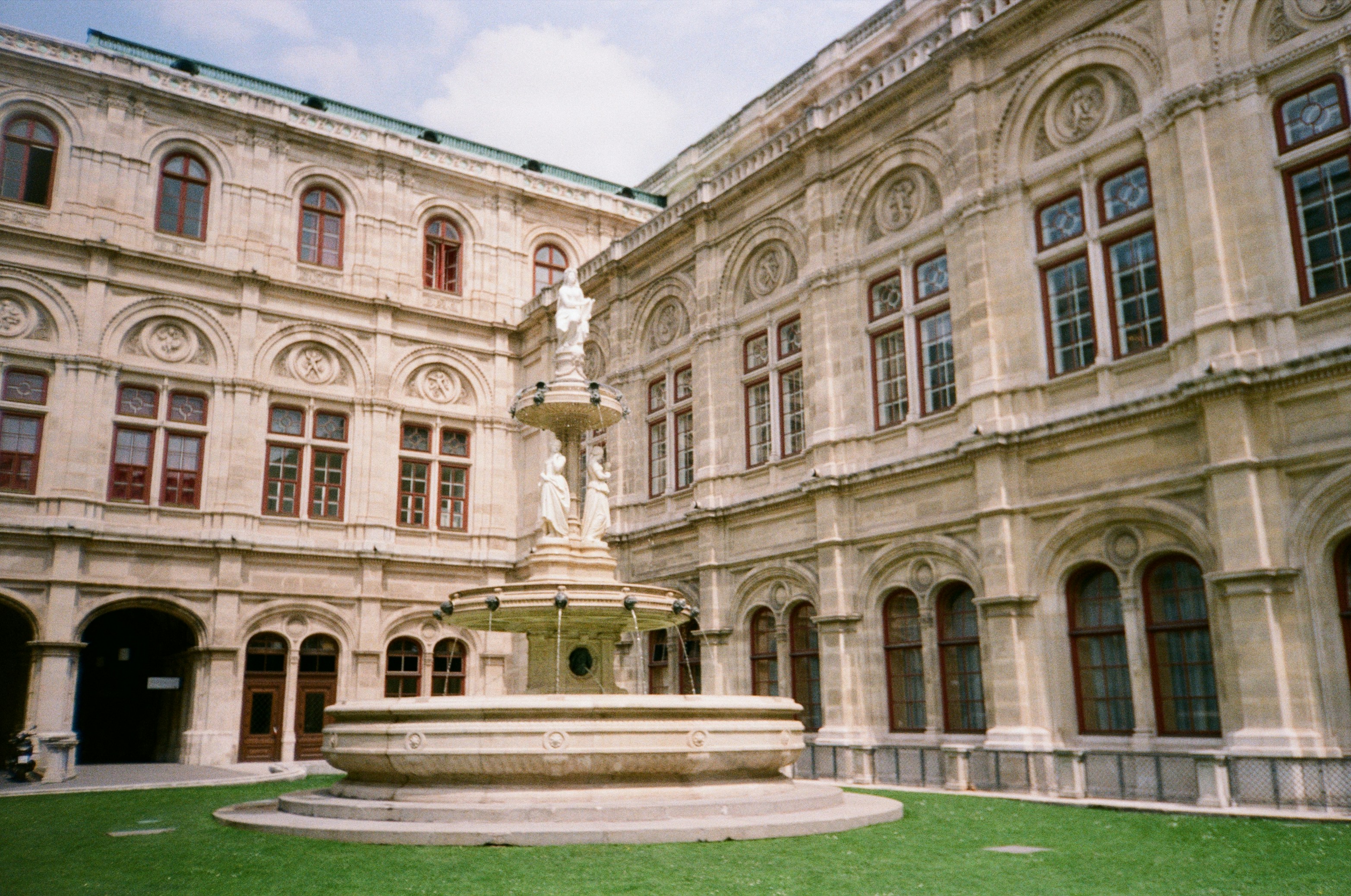 A large building with a fountain in front of it