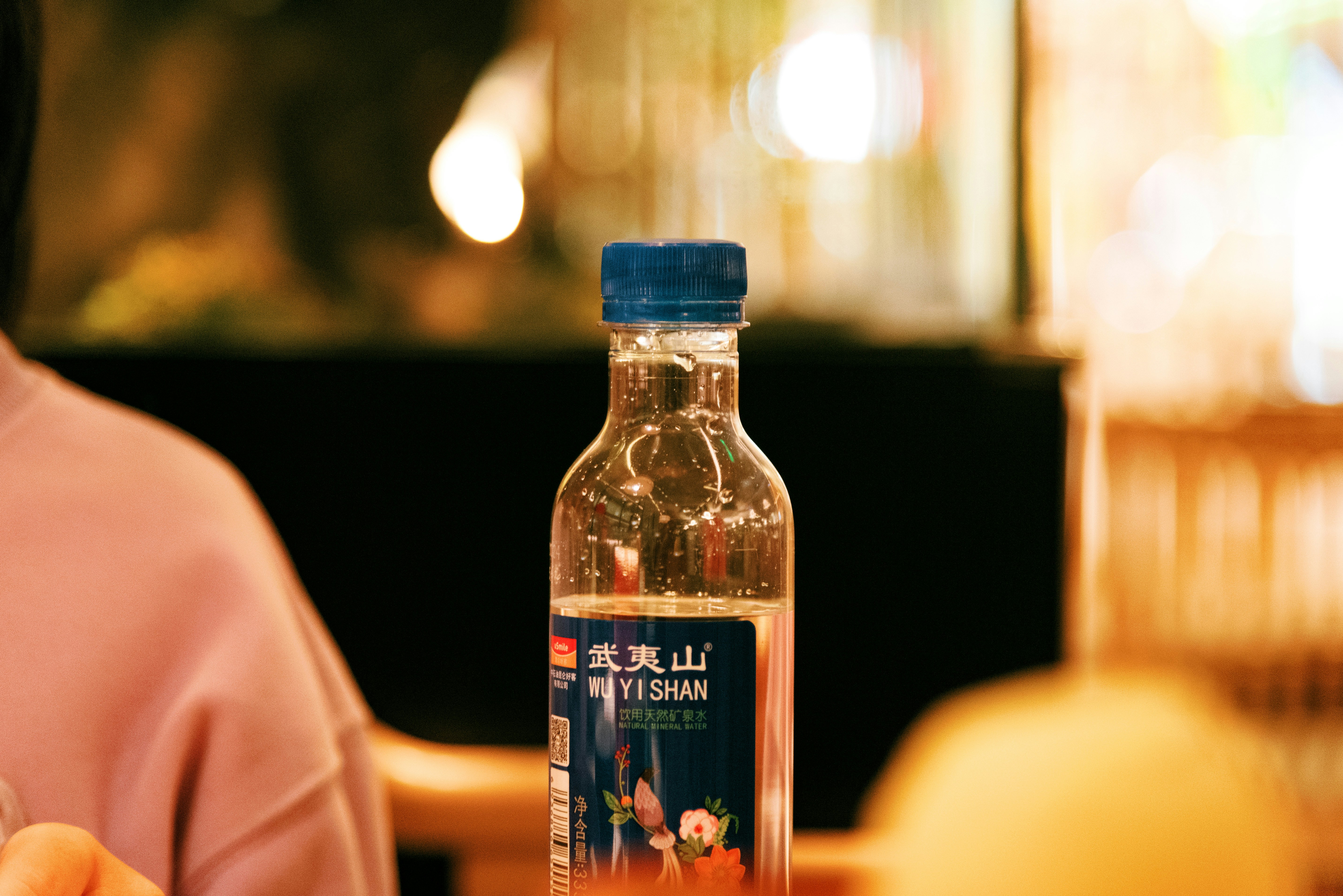 A bottle of water sitting on top of a table photo – Free Suzhou Image ...