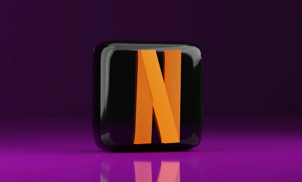 A black and orange letter n on a purple background