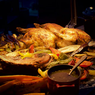 A roasting pan filled with roasted chicken and vegetables