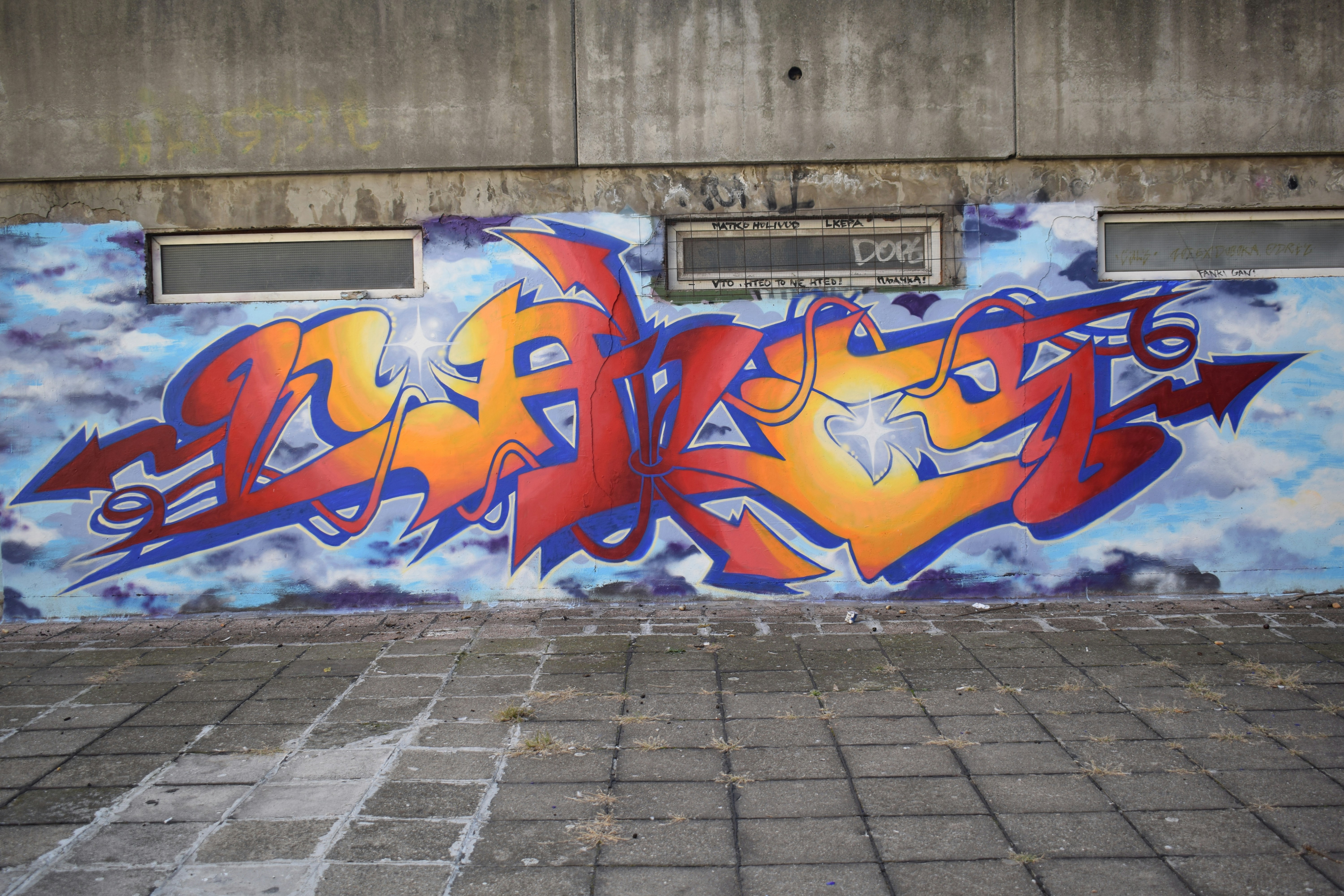 A wall that has some graffiti on it
