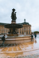 A group of people standing around a fountain