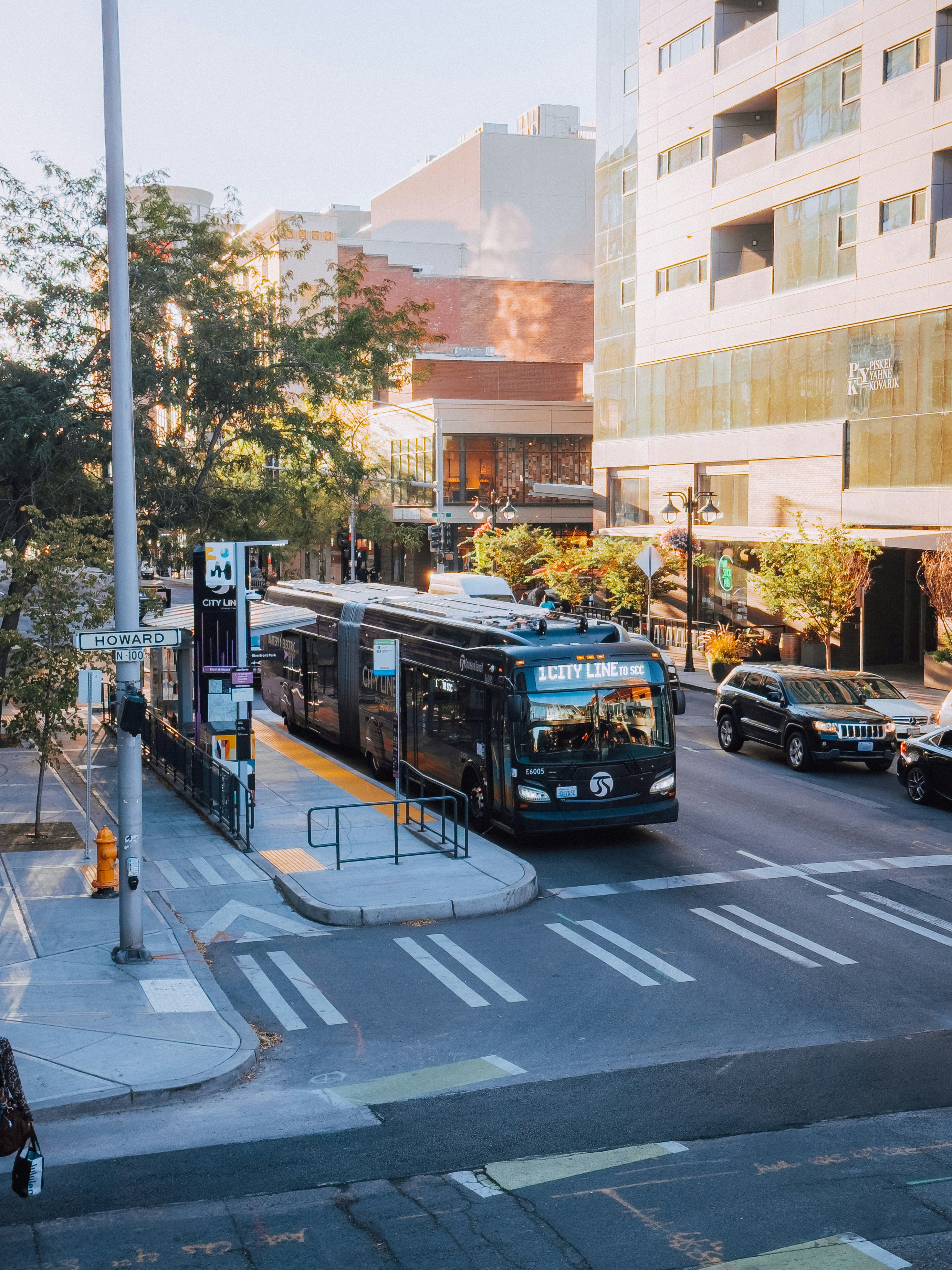 A city street filled with traffic next to tall buildings