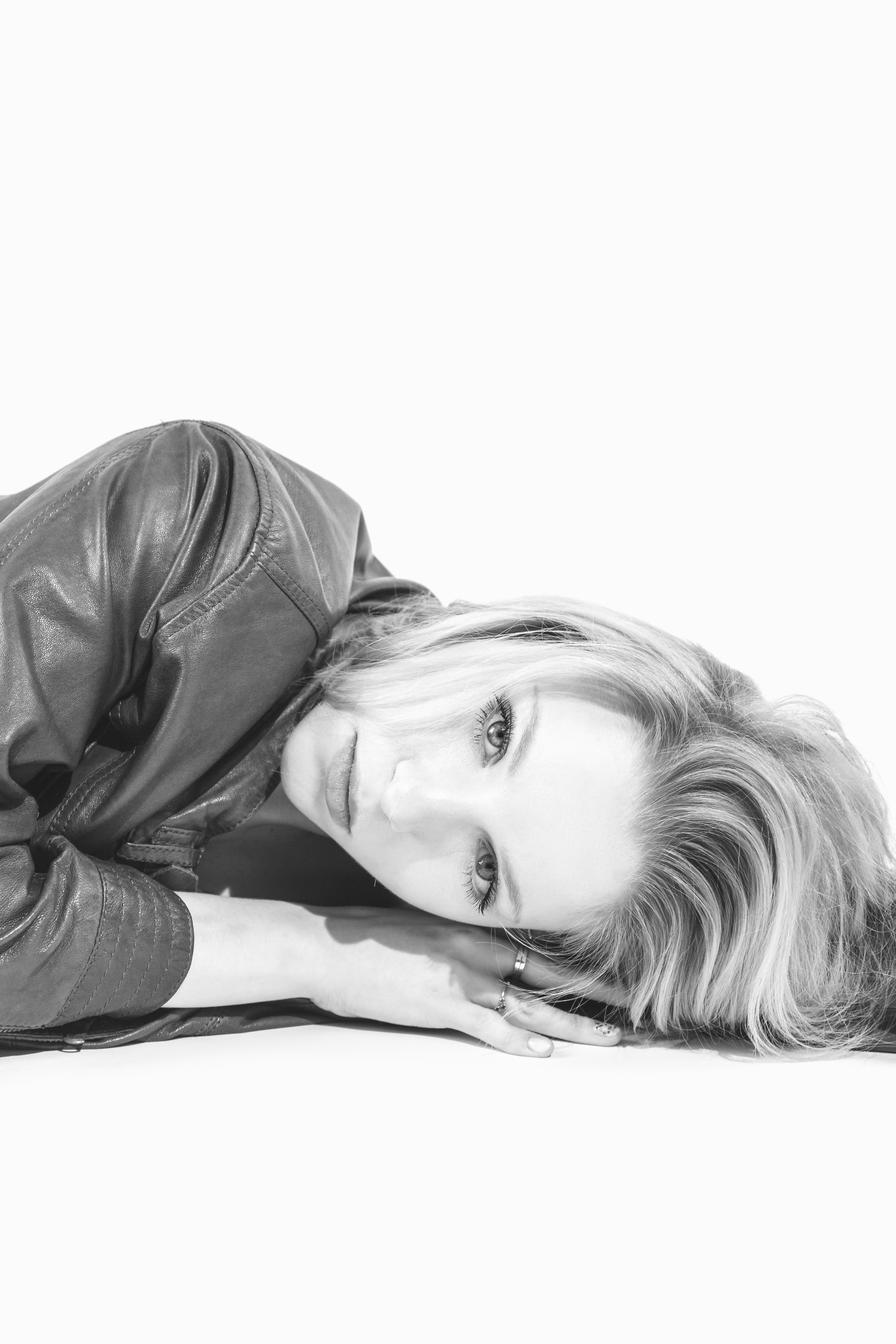 A black and white photo of a woman laying on the ground photo – Free ...