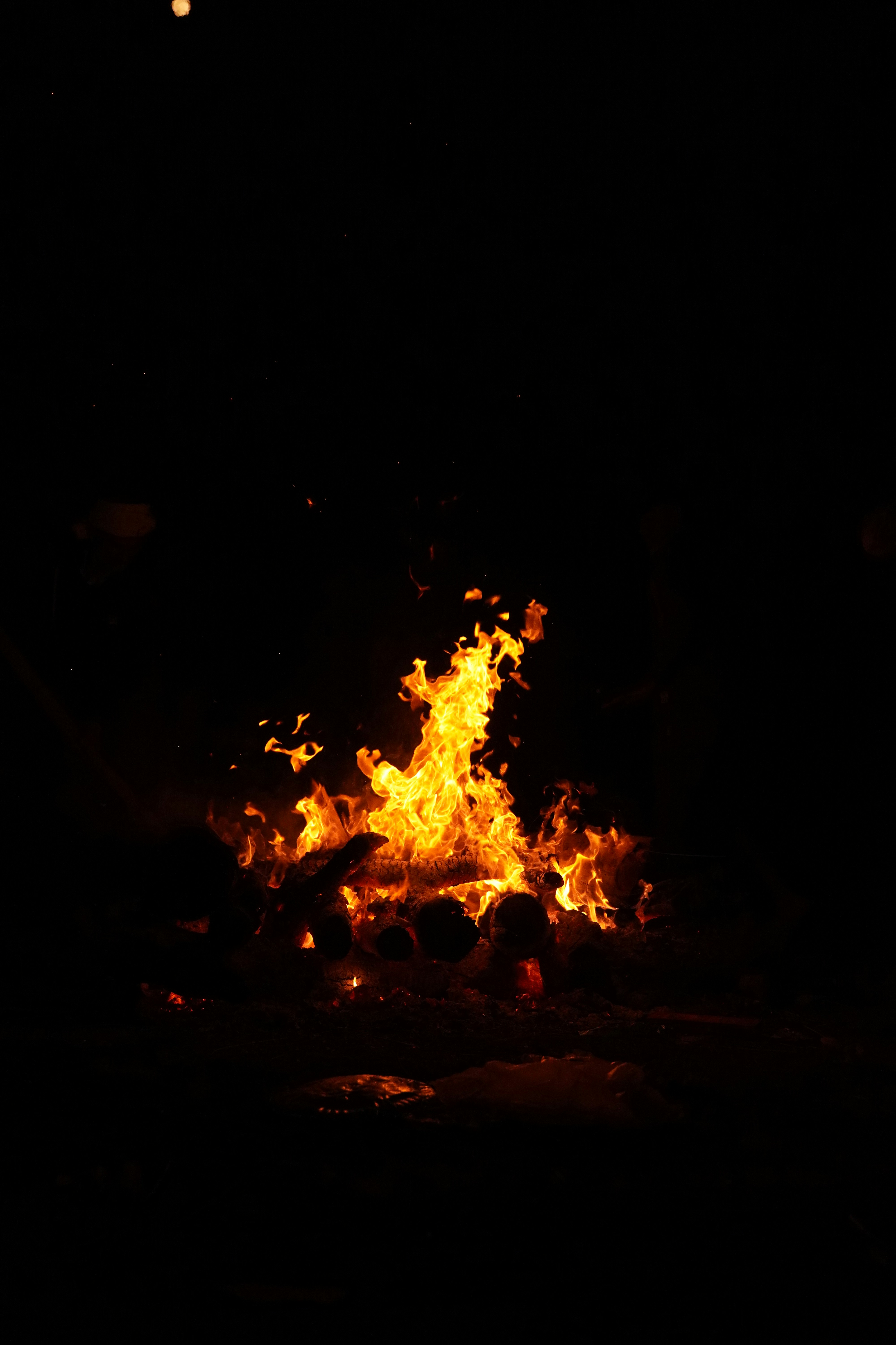 Un feu est allumé dans l’obscurité avec des flammes orange vif