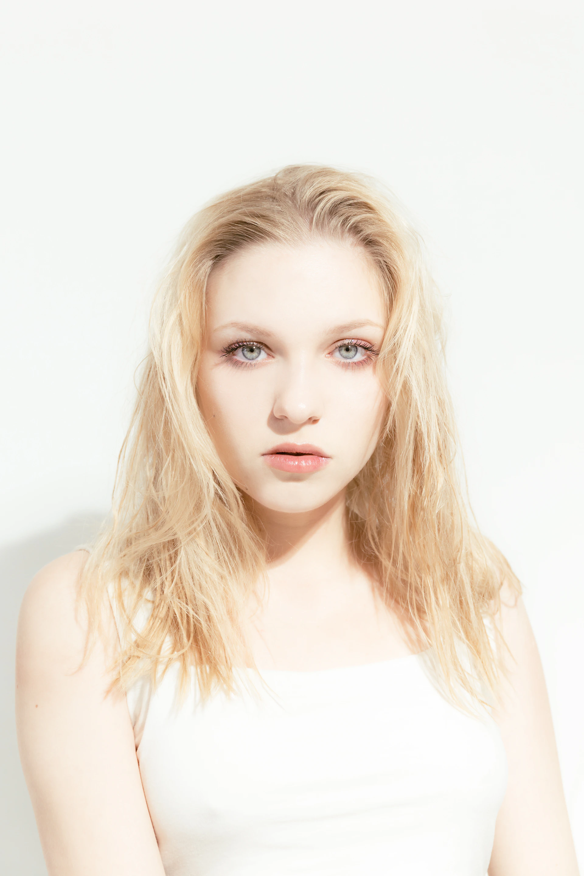 A woman in a white top posing for a picture