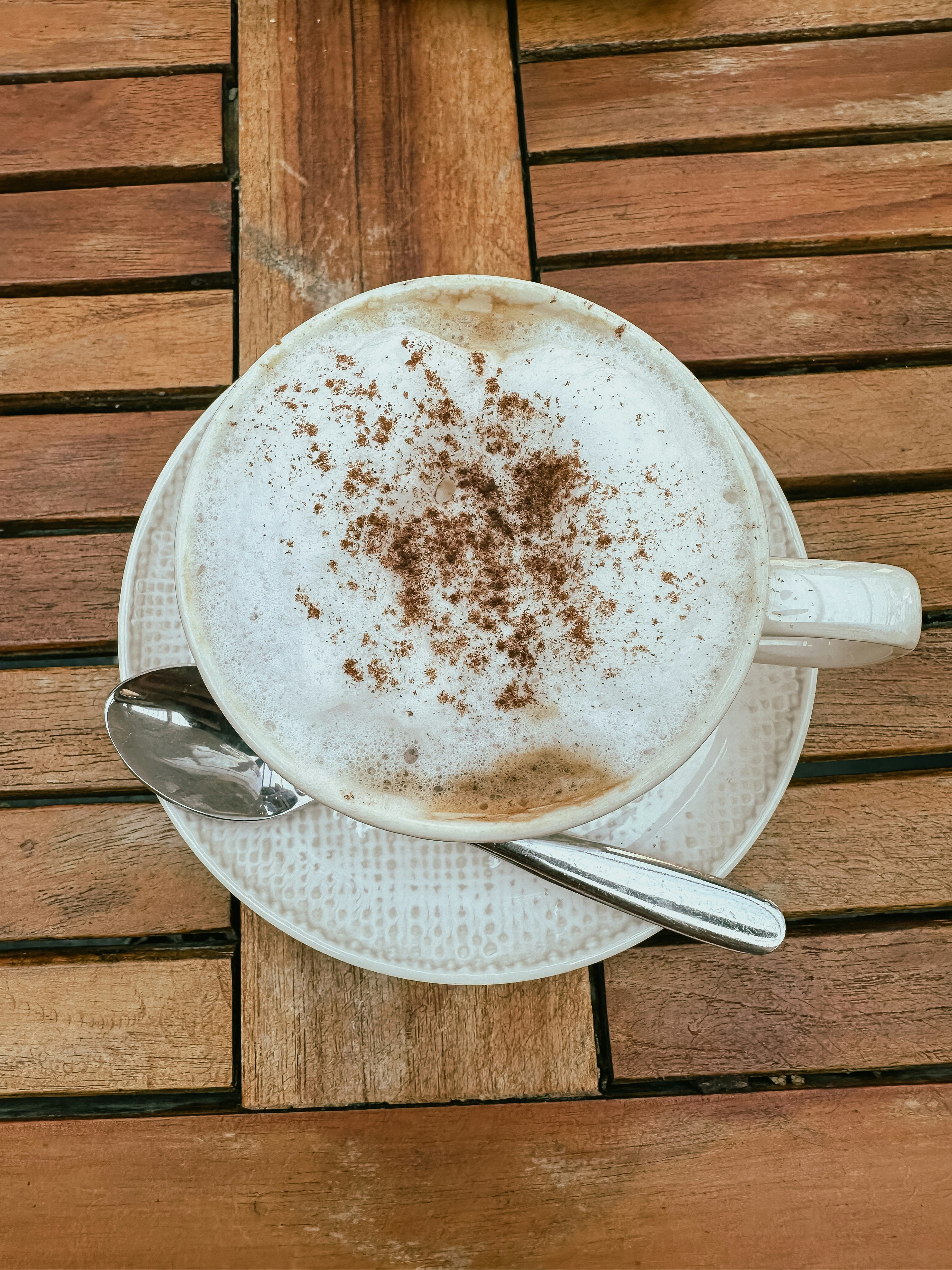 A cup of cappuccino on a wooden café table in New York City
