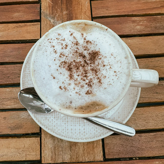 A cup of cappuccino on a wooden café table in New York City