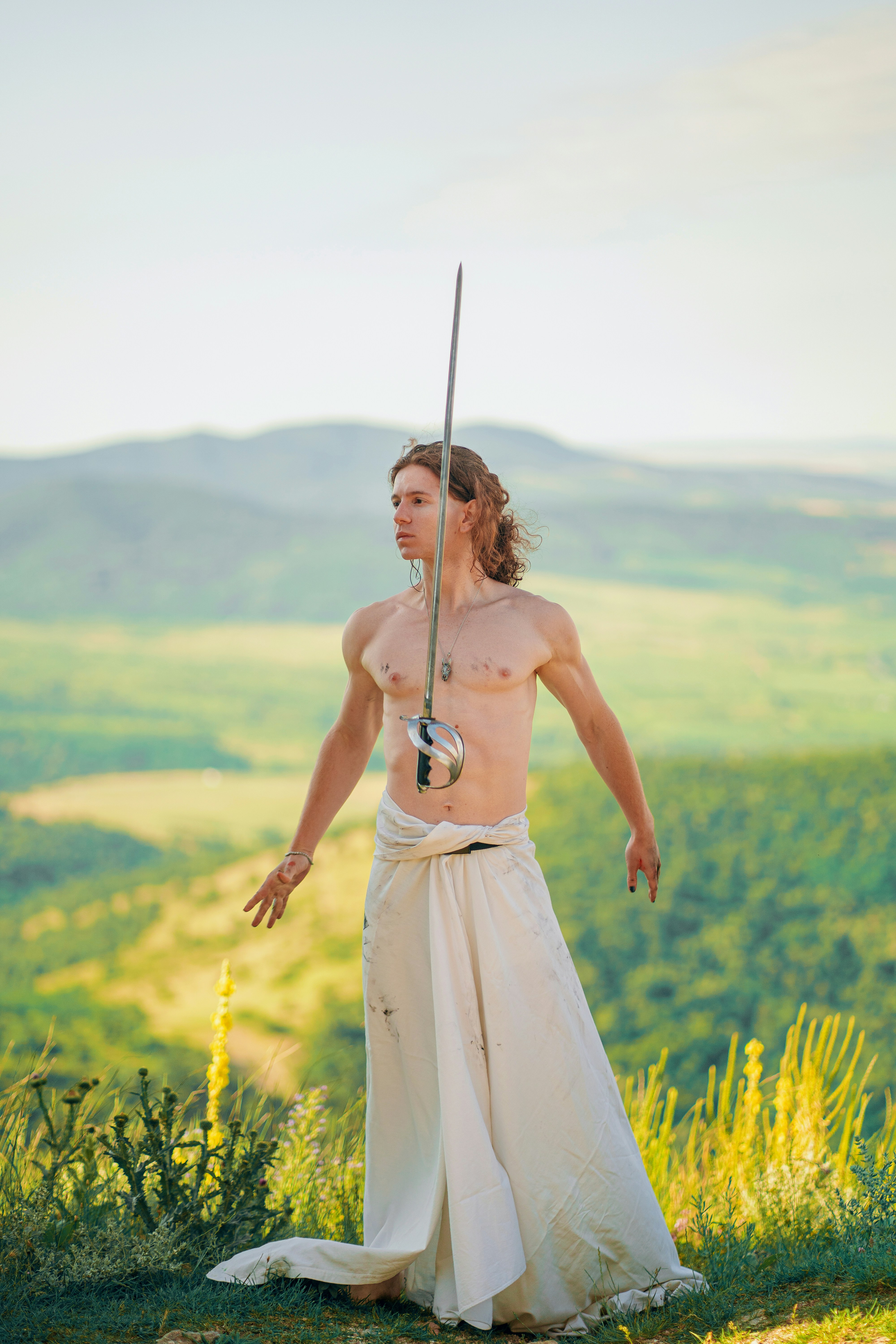 A woman in a white dress holding a sword