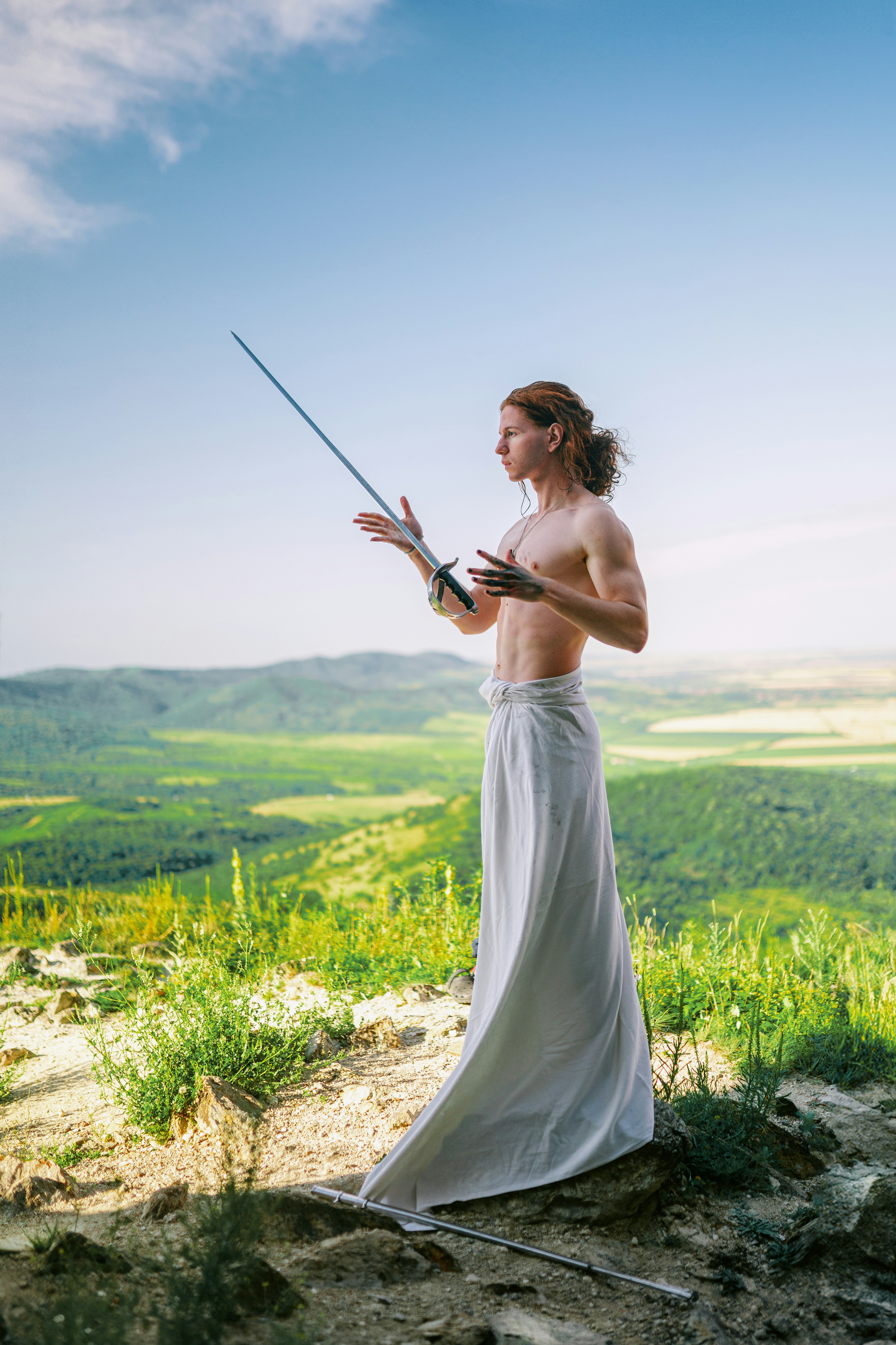 A woman in a white dress holding a sword