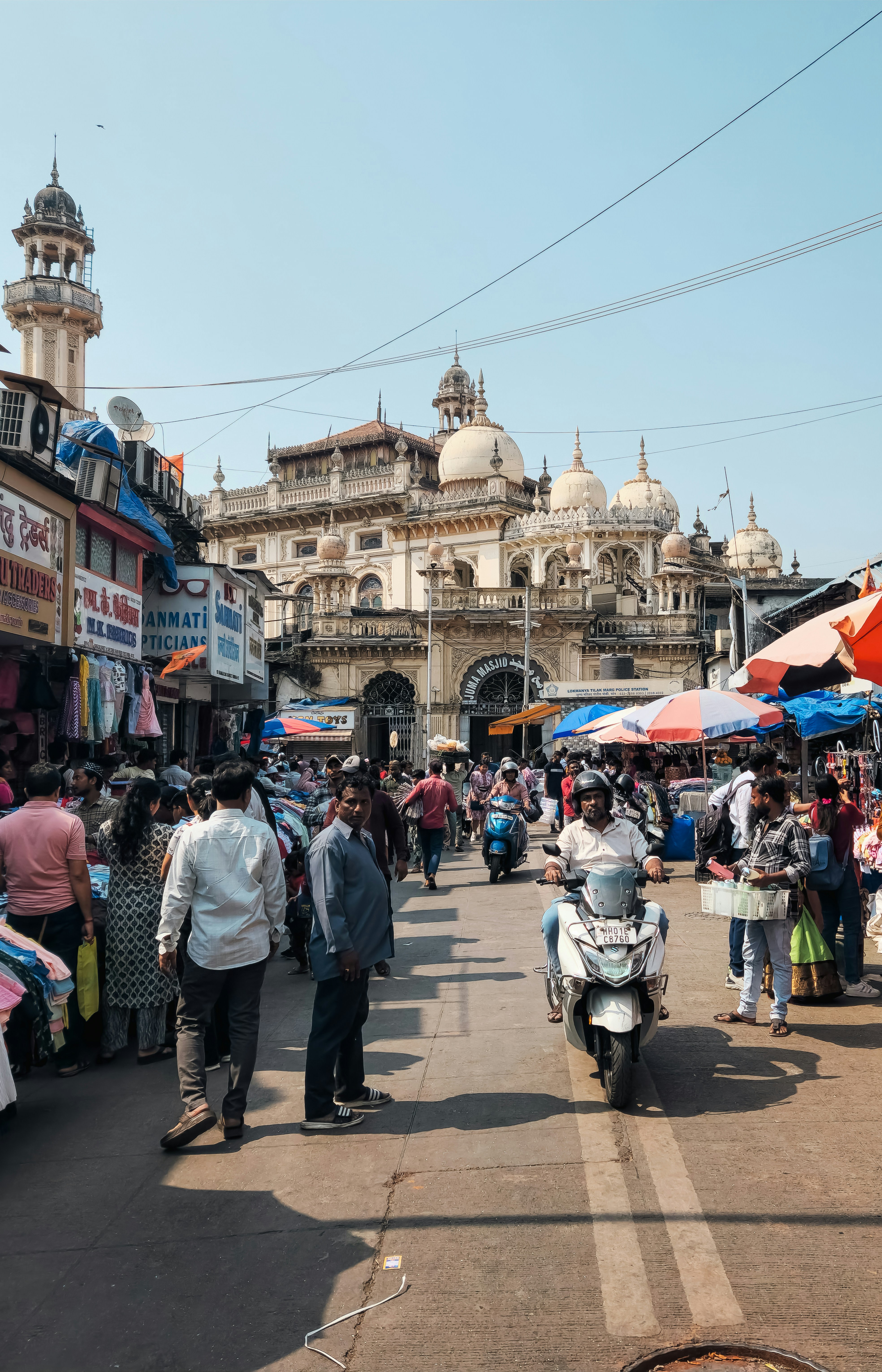 A group of people walking down a street