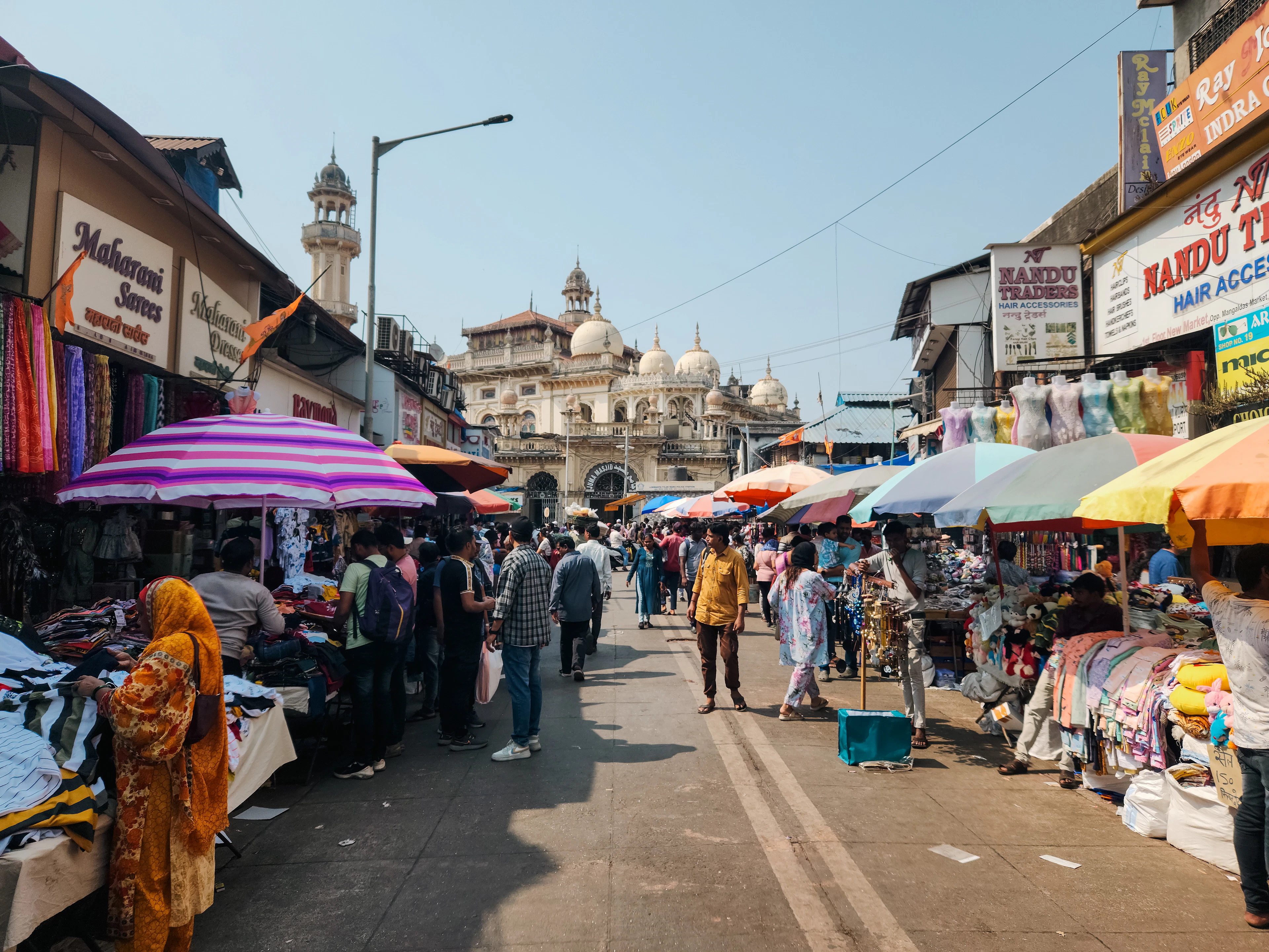 A busy Indian street with shops and pedestrians, used to demonstrate vision conditions