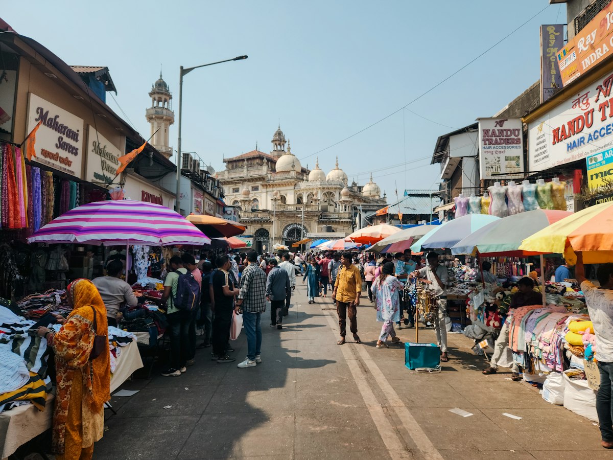 People walking down a street lined with shops