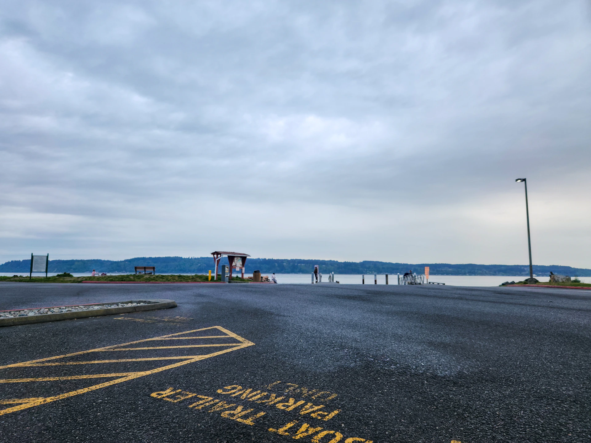 An empty parking lot with a view of the ocean