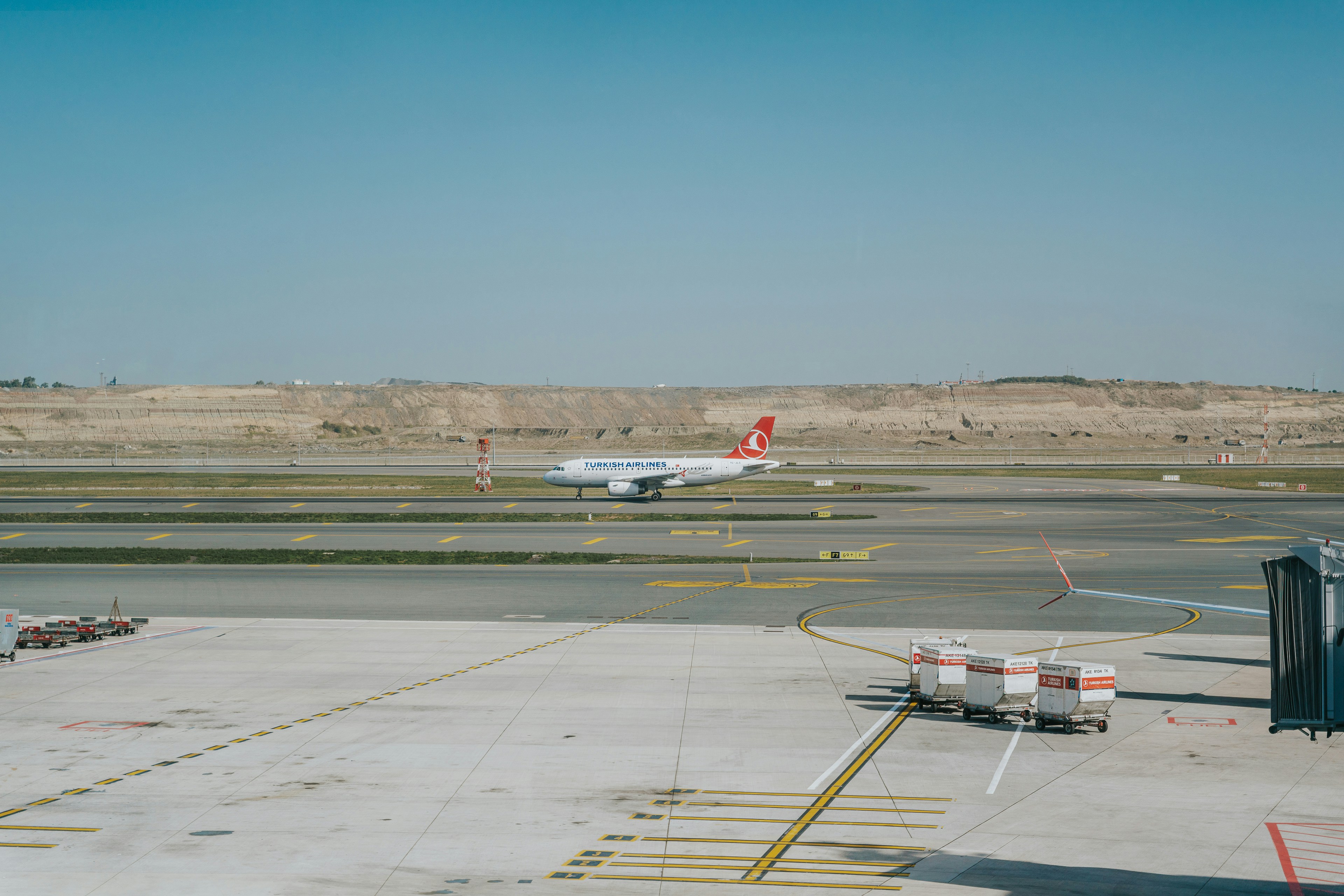 An airplane is parked on the tarmac at an airport, 