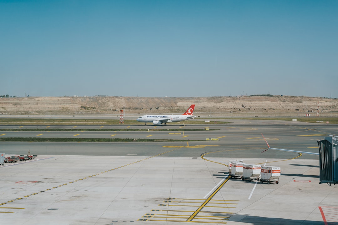 An airplane is parked on the tarmac at an airport,