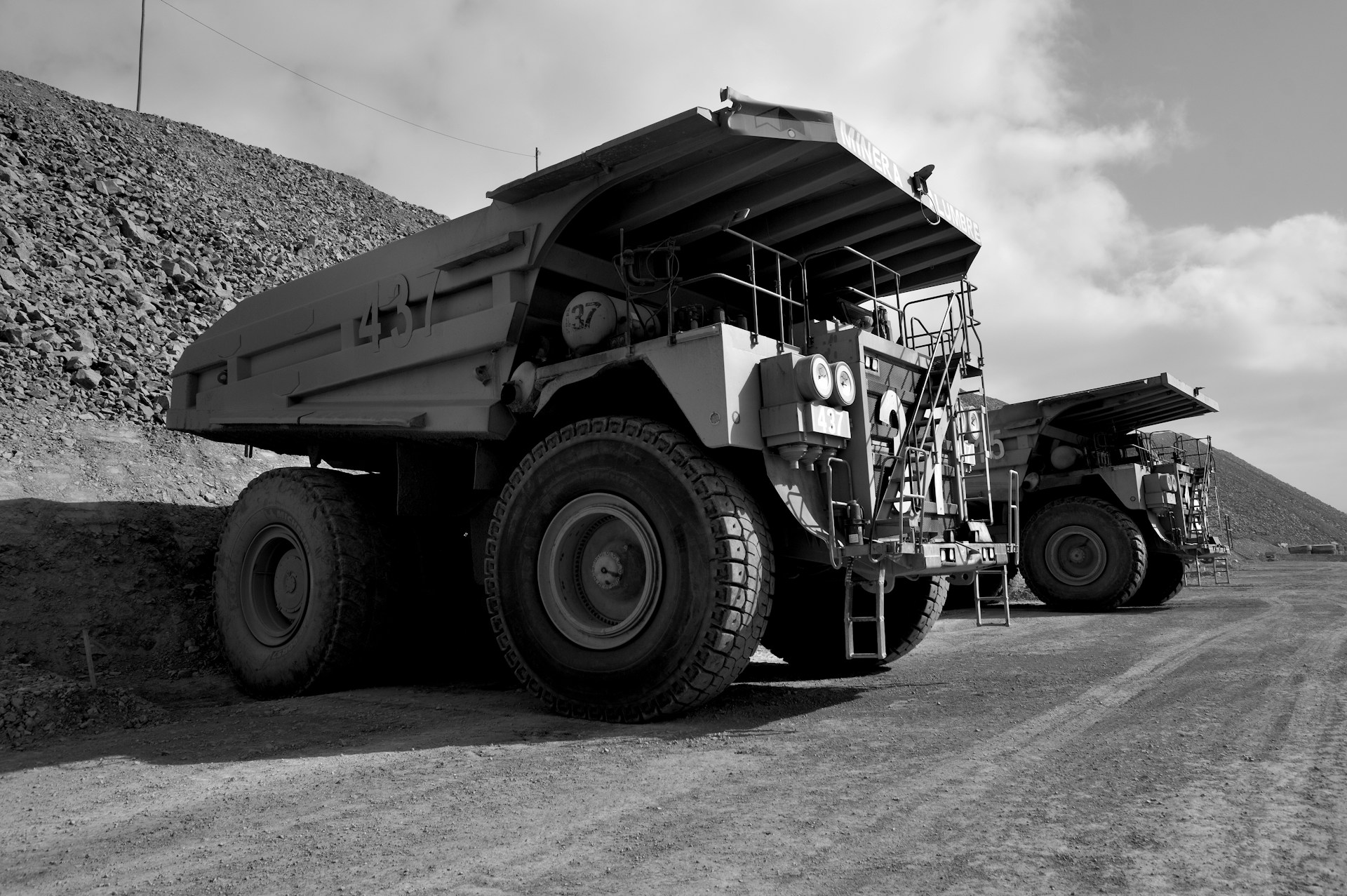 A large truck driving down a dirt road