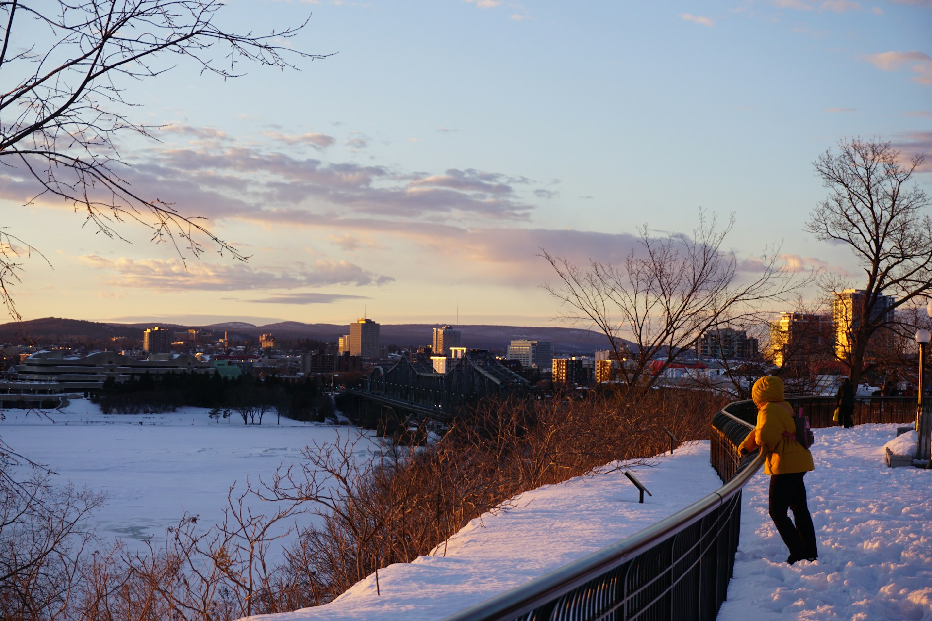 A person standing on top of a snow covered hill