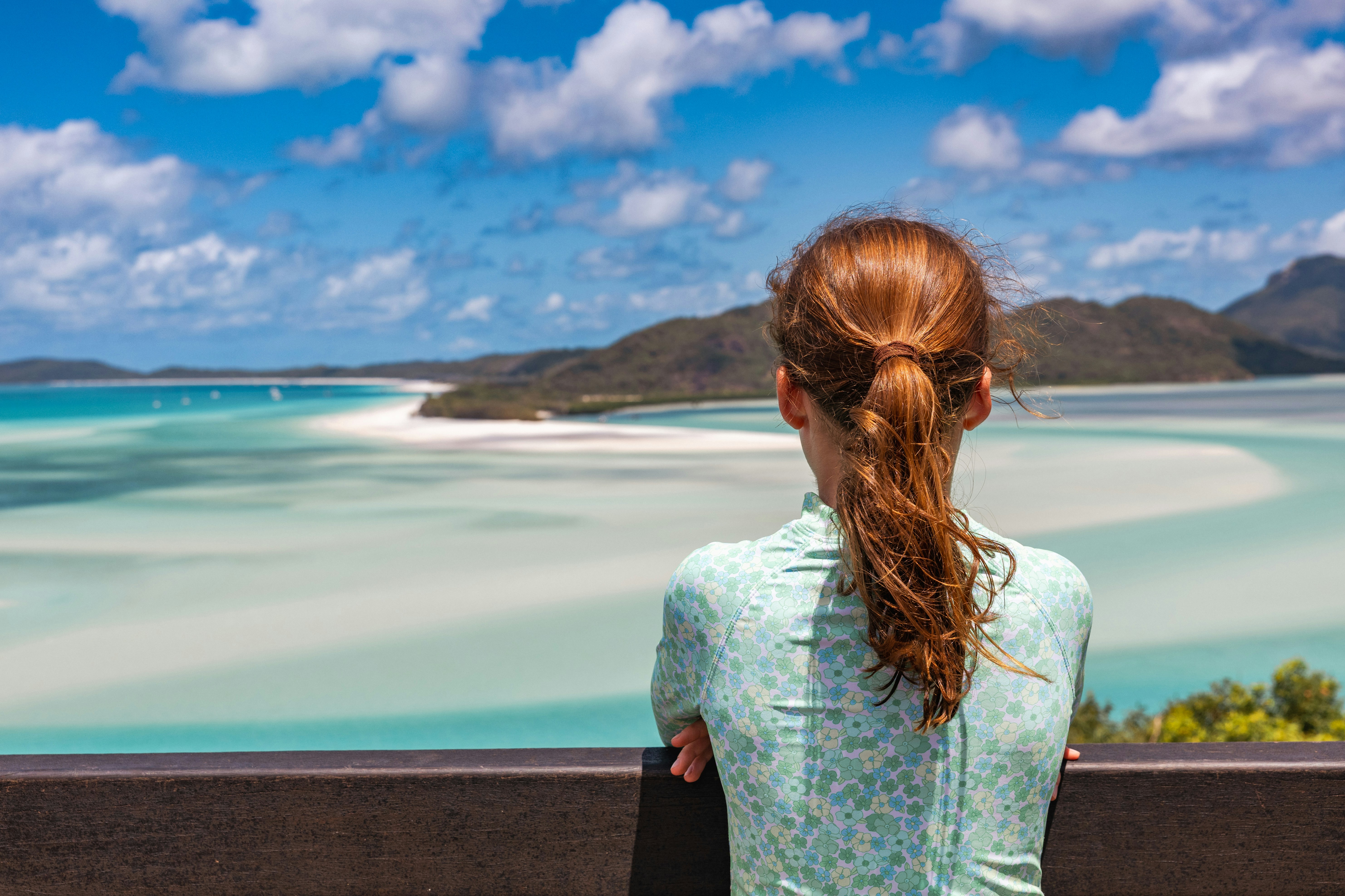 A woman looking out over the ocean from a lookout