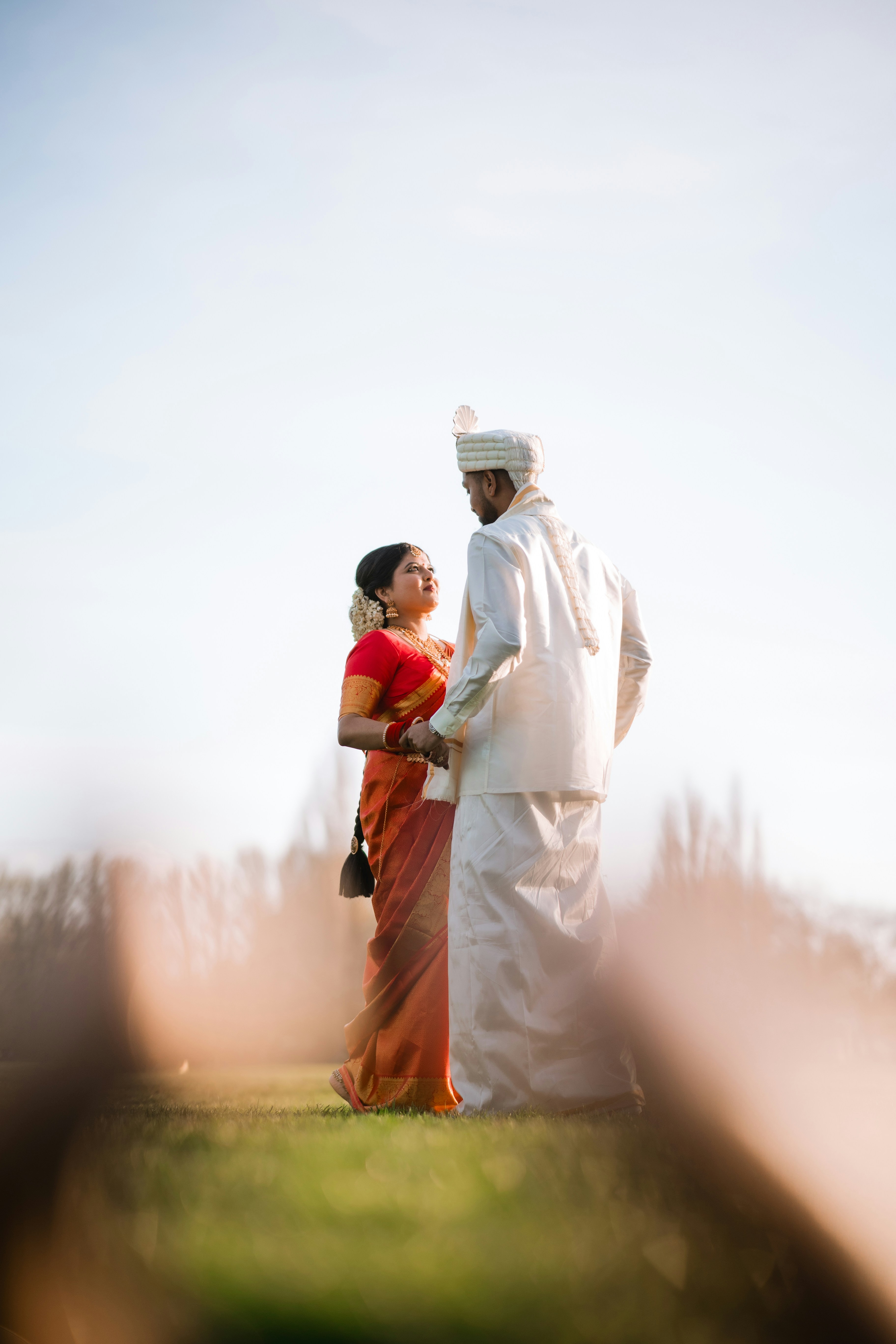 A couple of people that are standing in the grass