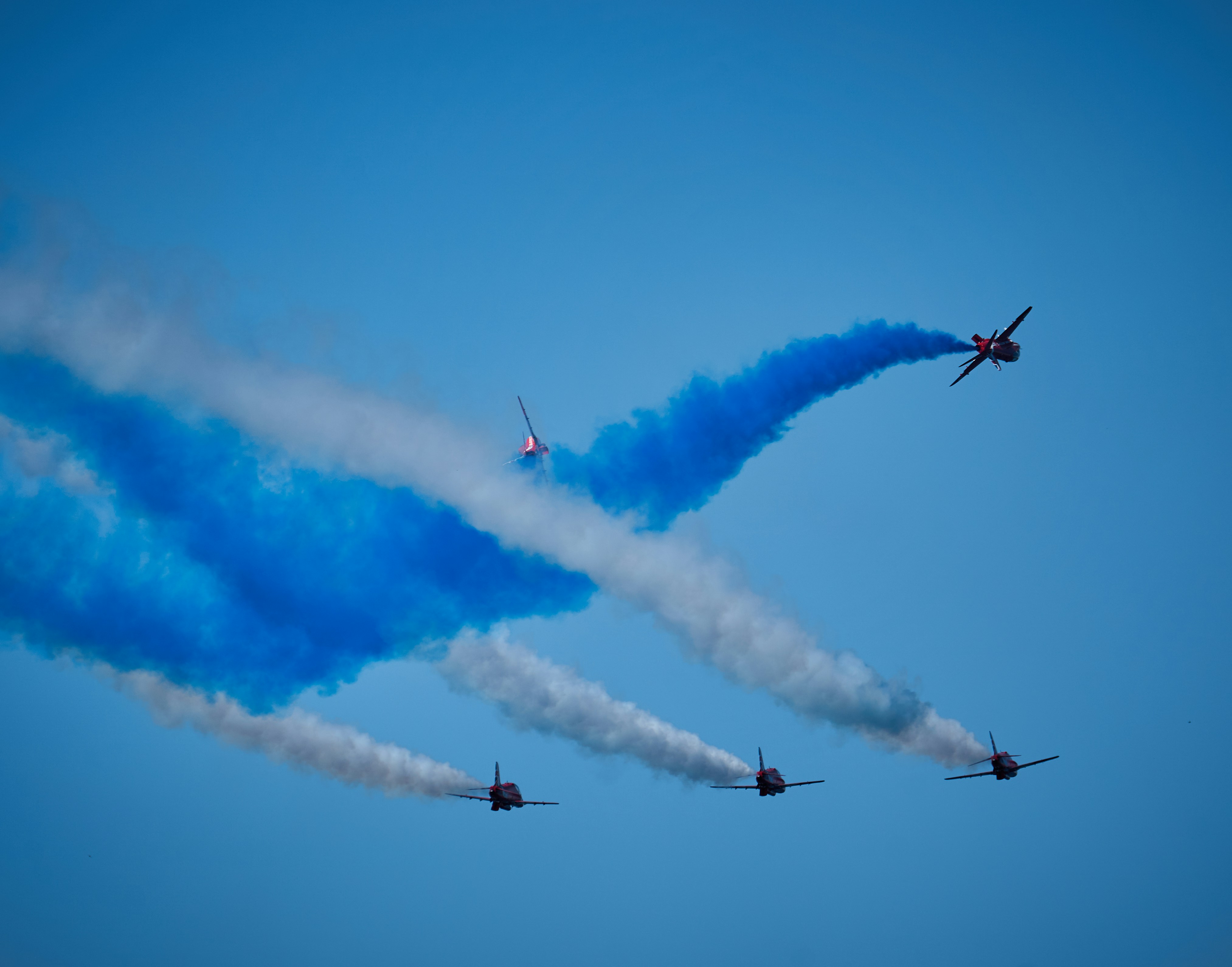 A group of airplanes flying in formation in the sky