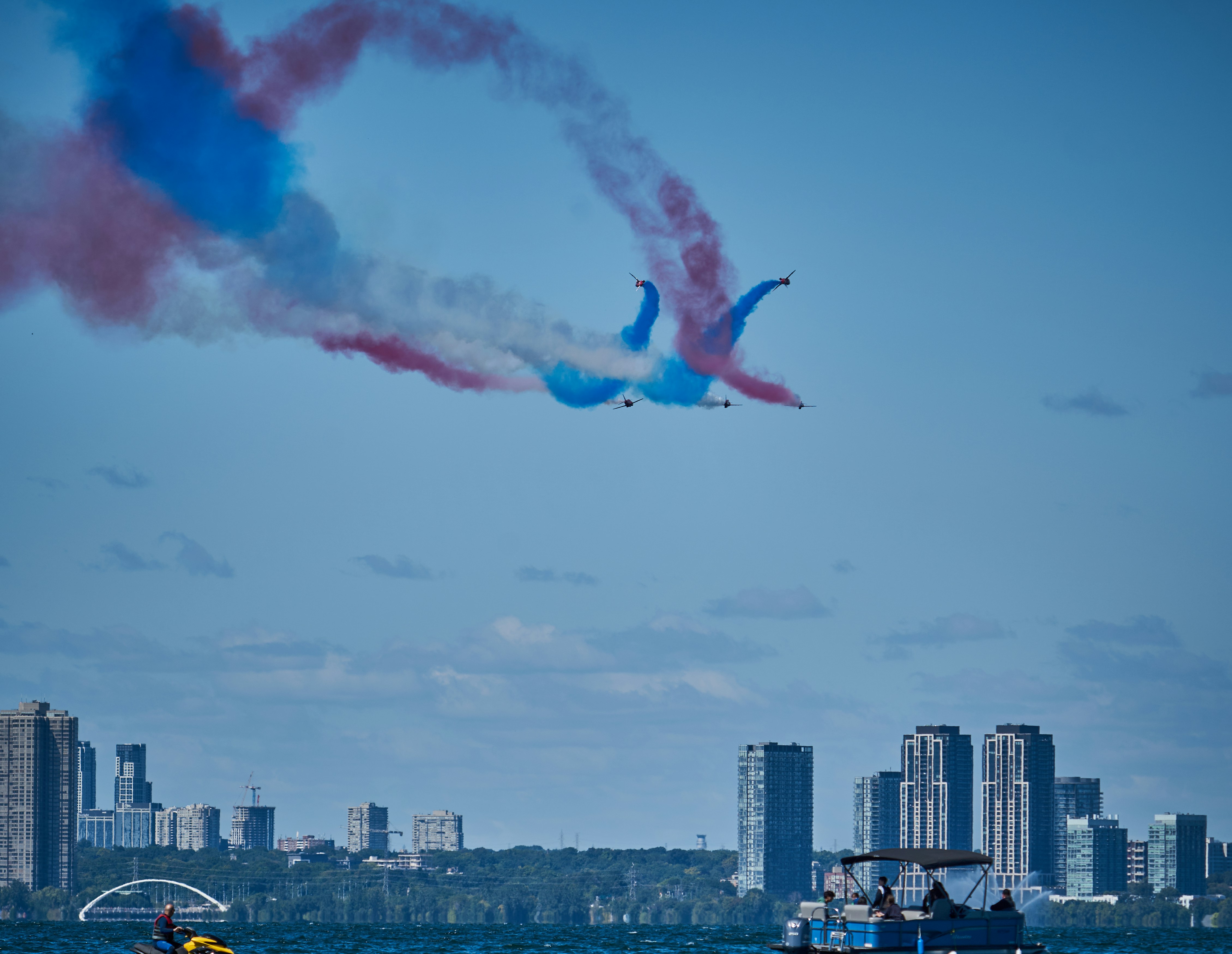 A couple of jets flying over a body of water