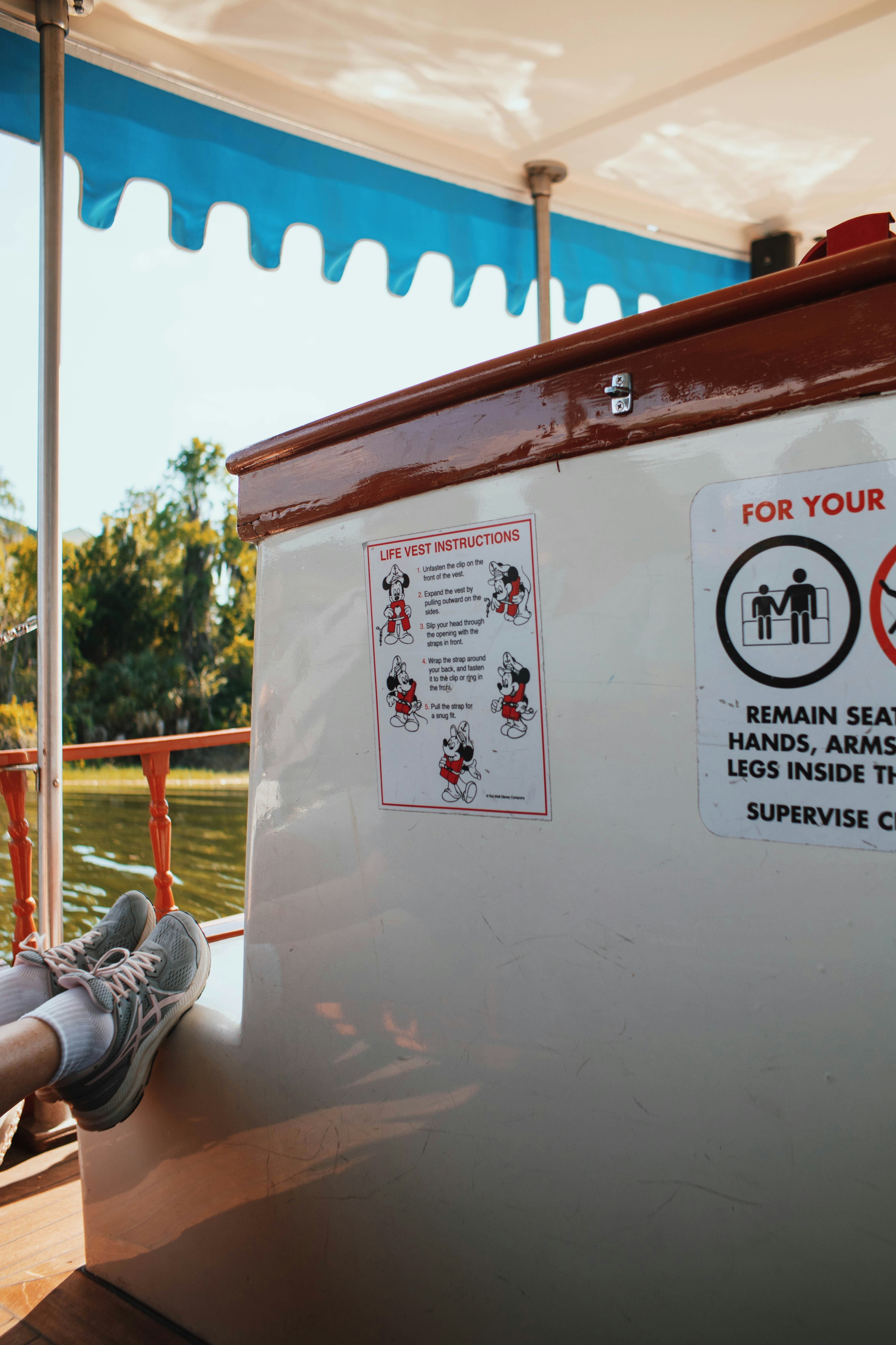 A person sitting on a bench next to a sign