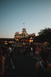 A crowd of people walking around a building