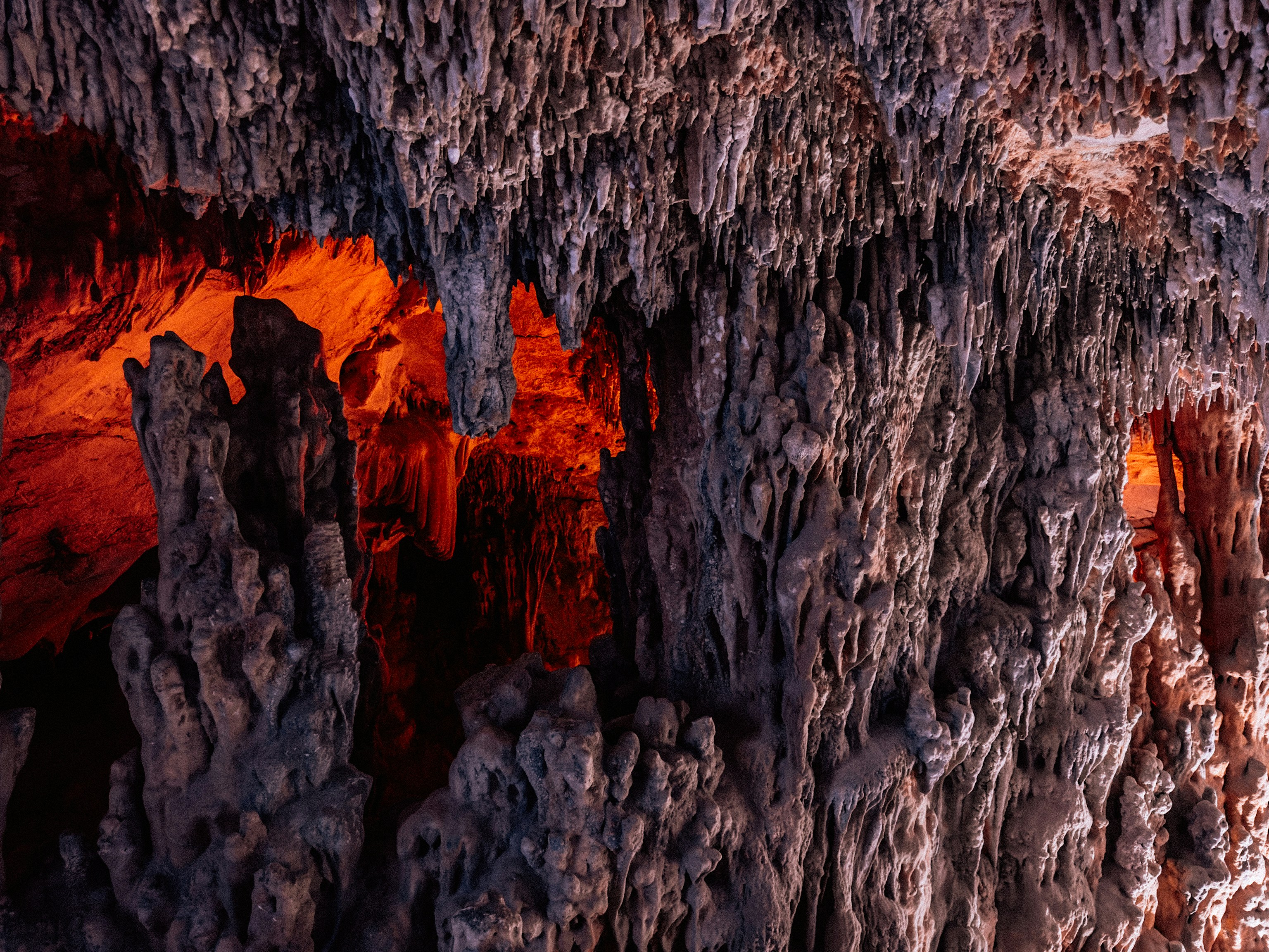 A large rock formation with red light coming from it