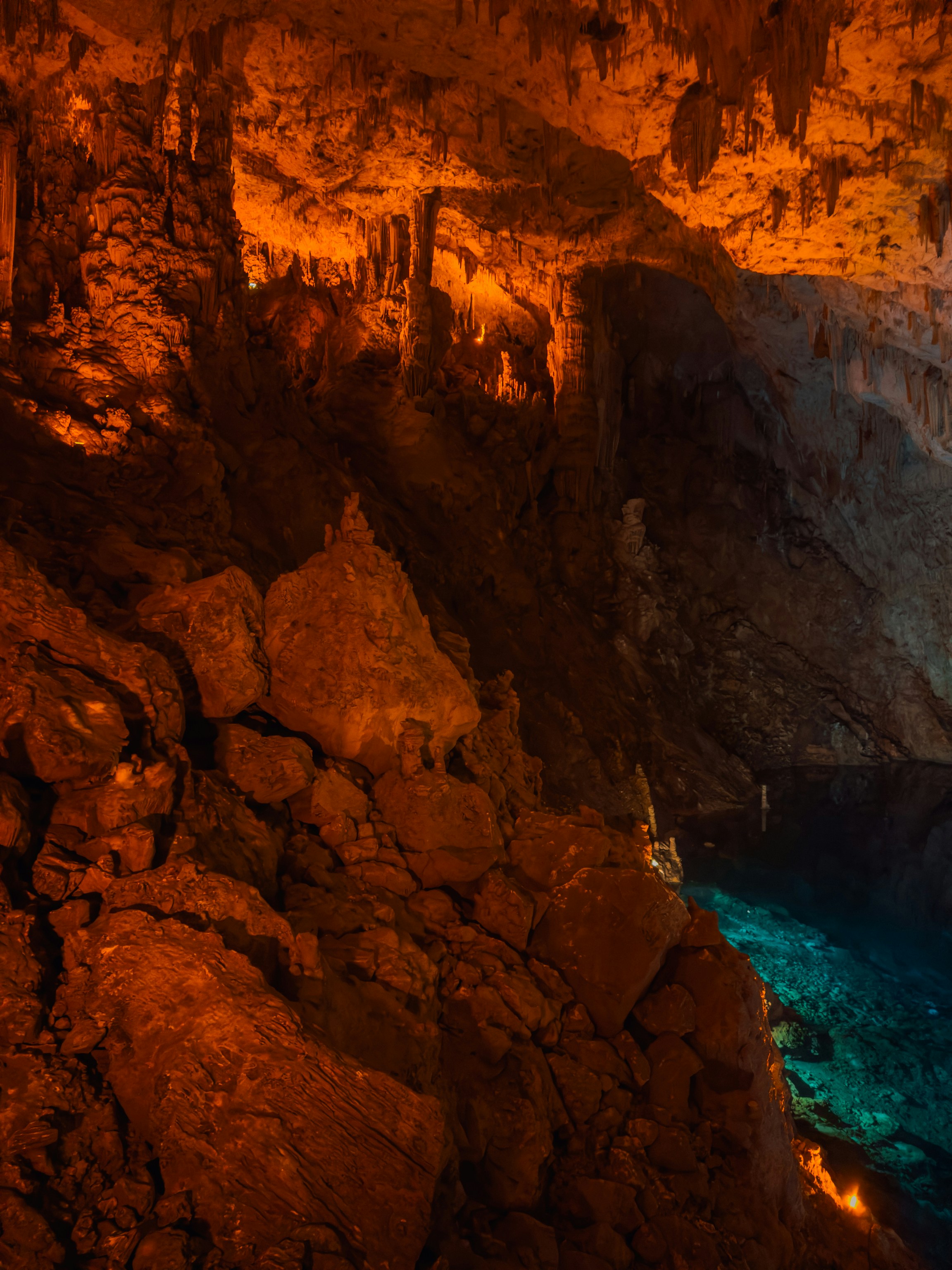 A cave filled with lots of blue water