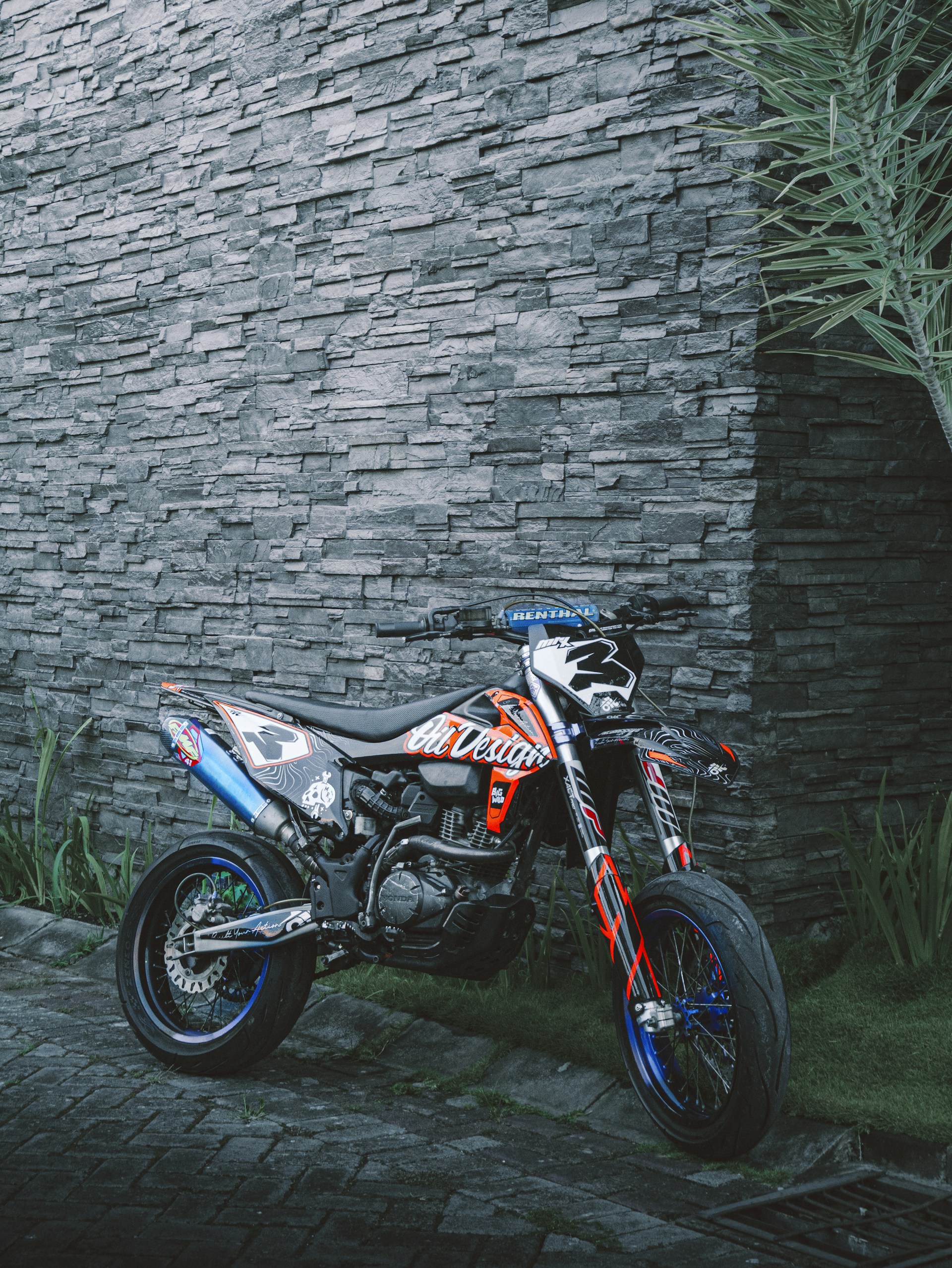 A motorcycle parked next to a brick wall